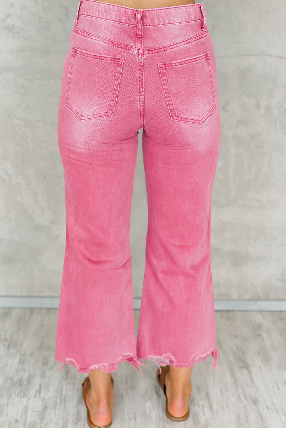 A pair of Peach Blossom Distressed Hollow-out High Waist Cropped Flare Jeans showcasing a vintage style with unique distressed details.