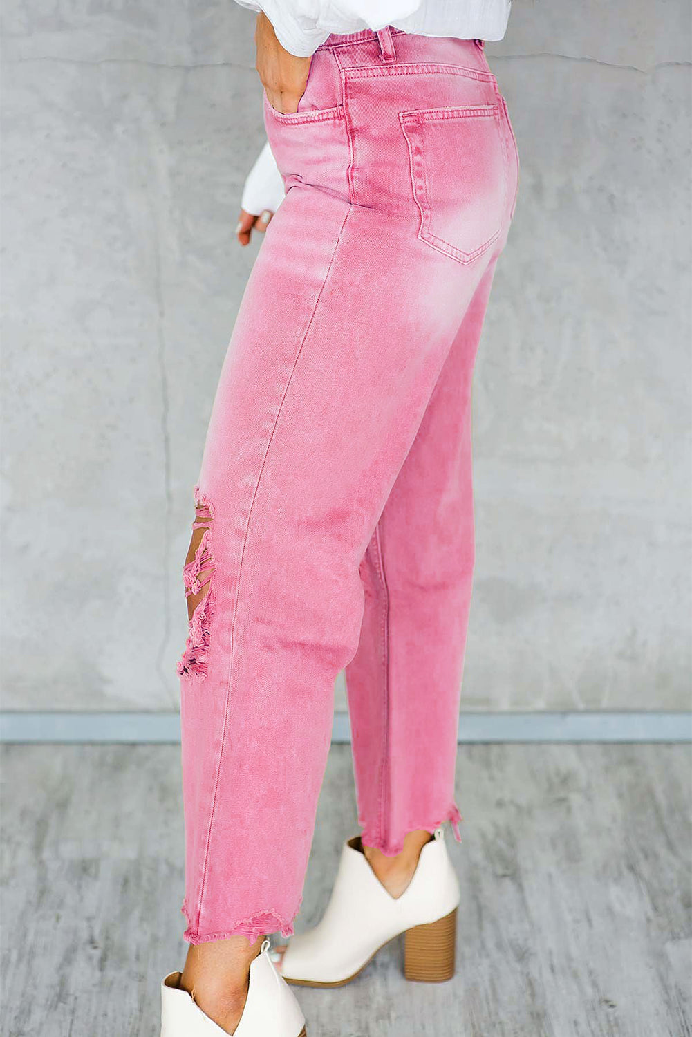 A pair of Peach Blossom Distressed Hollow-out High Waist Cropped Flare Jeans showcasing a vintage style with unique distressed details.