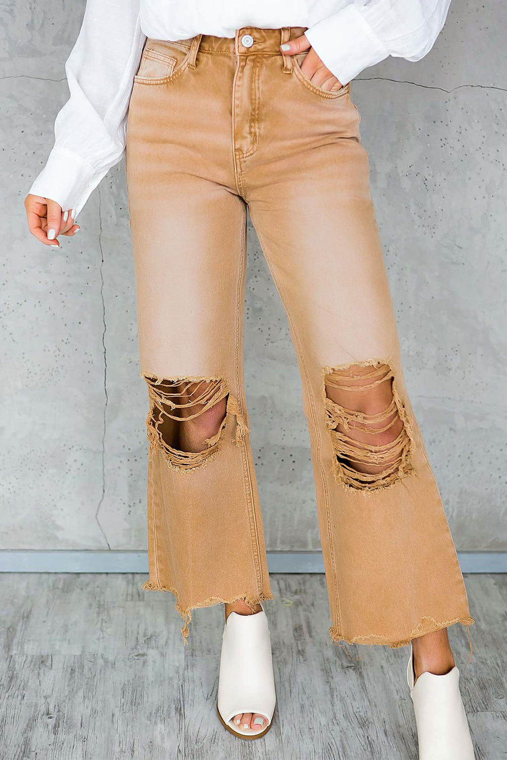 A pair of Peach Blossom Distressed Hollow-out High Waist Cropped Flare Jeans showcasing a vintage style with unique distressed details.