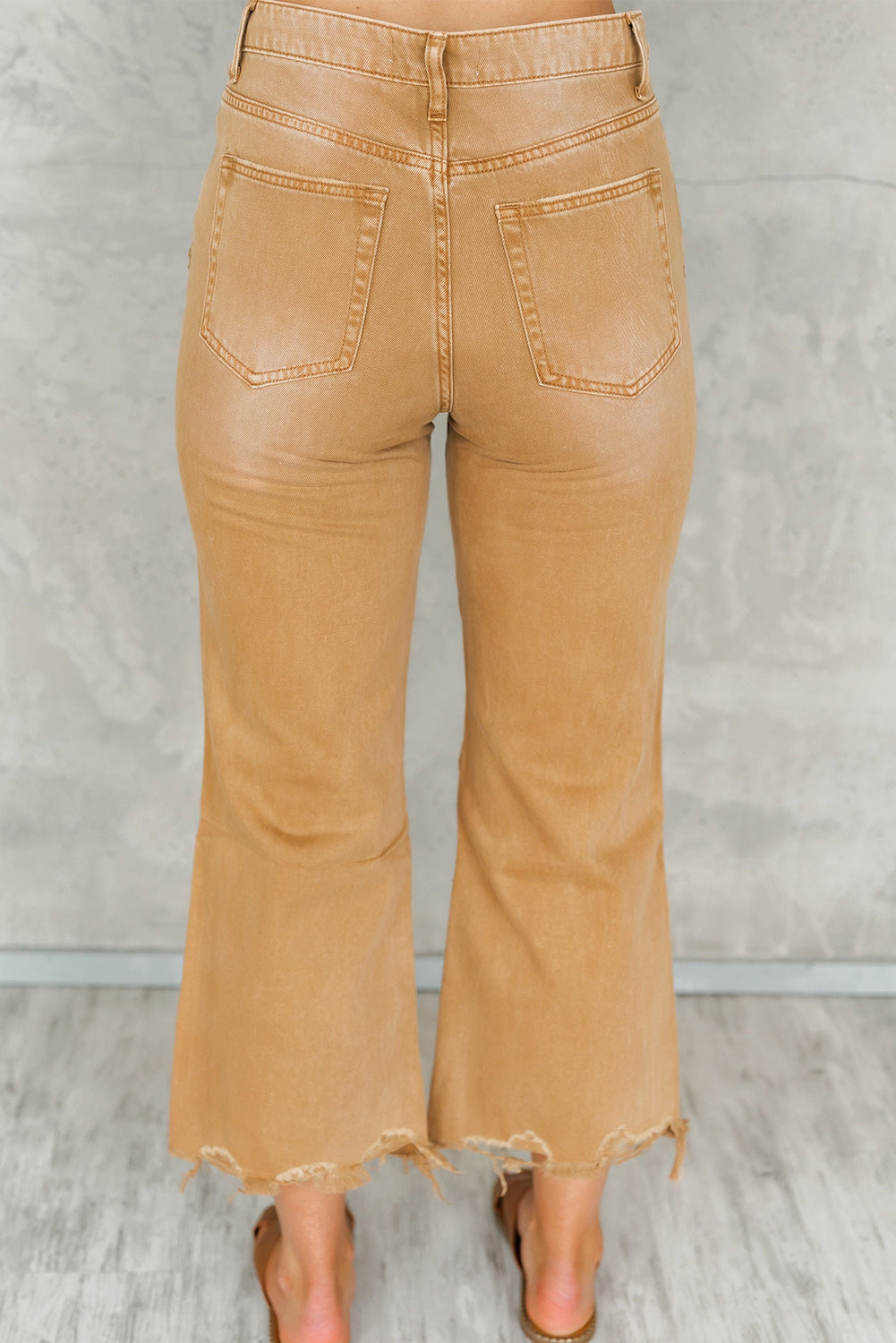 A pair of Peach Blossom Distressed Hollow-out High Waist Cropped Flare Jeans showcasing a vintage style with unique distressed details.