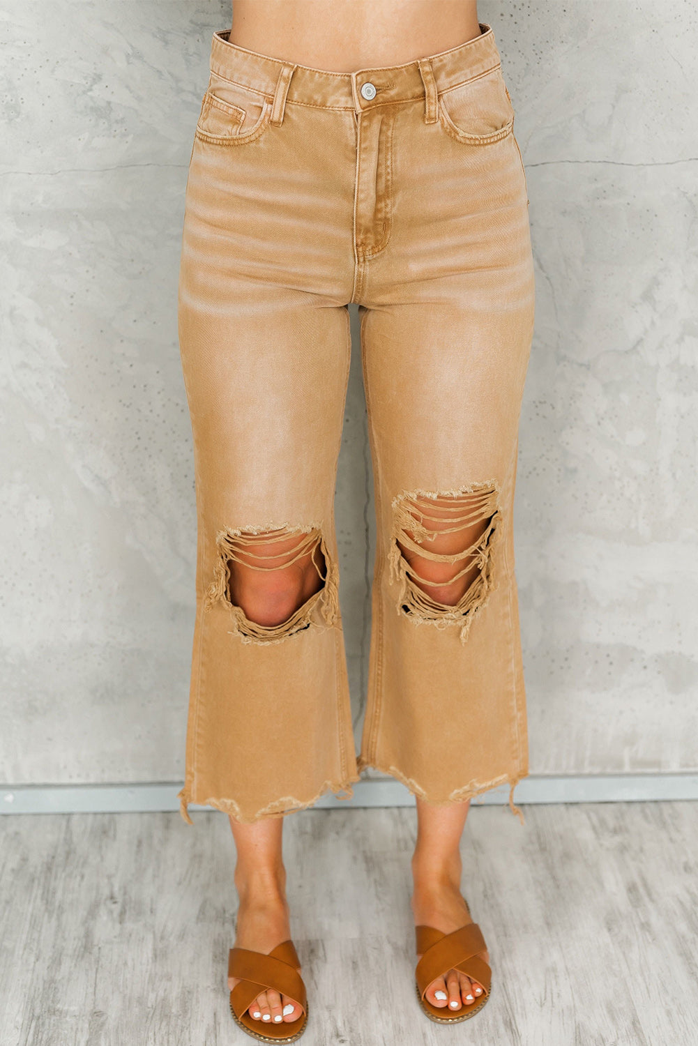 A pair of Peach Blossom Distressed Hollow-out High Waist Cropped Flare Jeans showcasing a vintage style with unique distressed details.