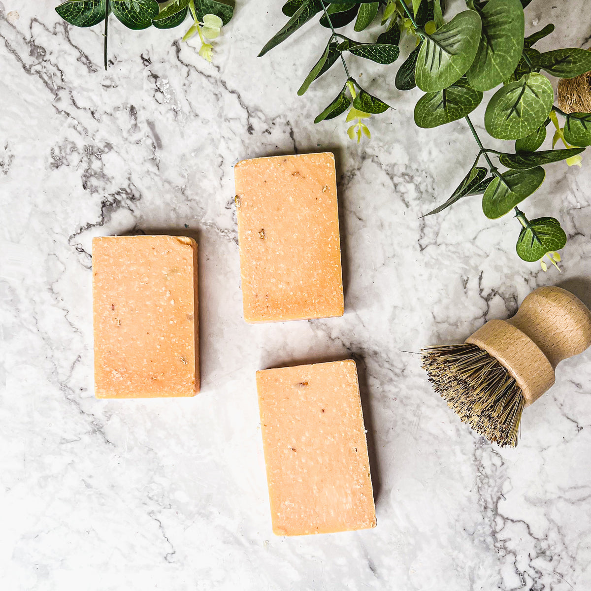 A vibrant Peach Tea Scrub soap bar with a sweet peach fragrance, featuring a unique handmade design and gentle exfoliating properties.