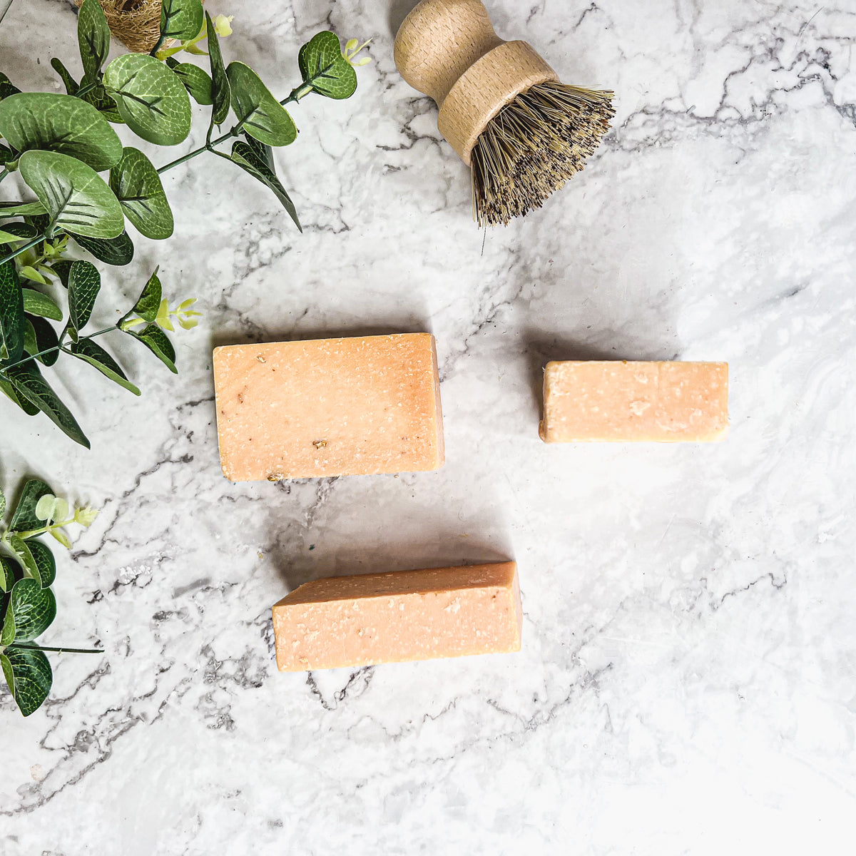 A vibrant Peach Tea Scrub soap bar with a sweet peach fragrance, featuring a unique handmade design and gentle exfoliating properties.