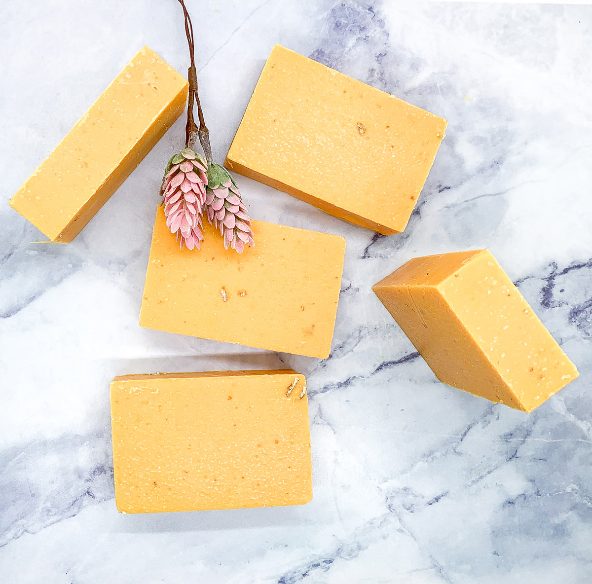 A vibrant Peach Tea Scrub soap bar with a sweet peach fragrance, featuring a unique handmade design and gentle exfoliating properties.