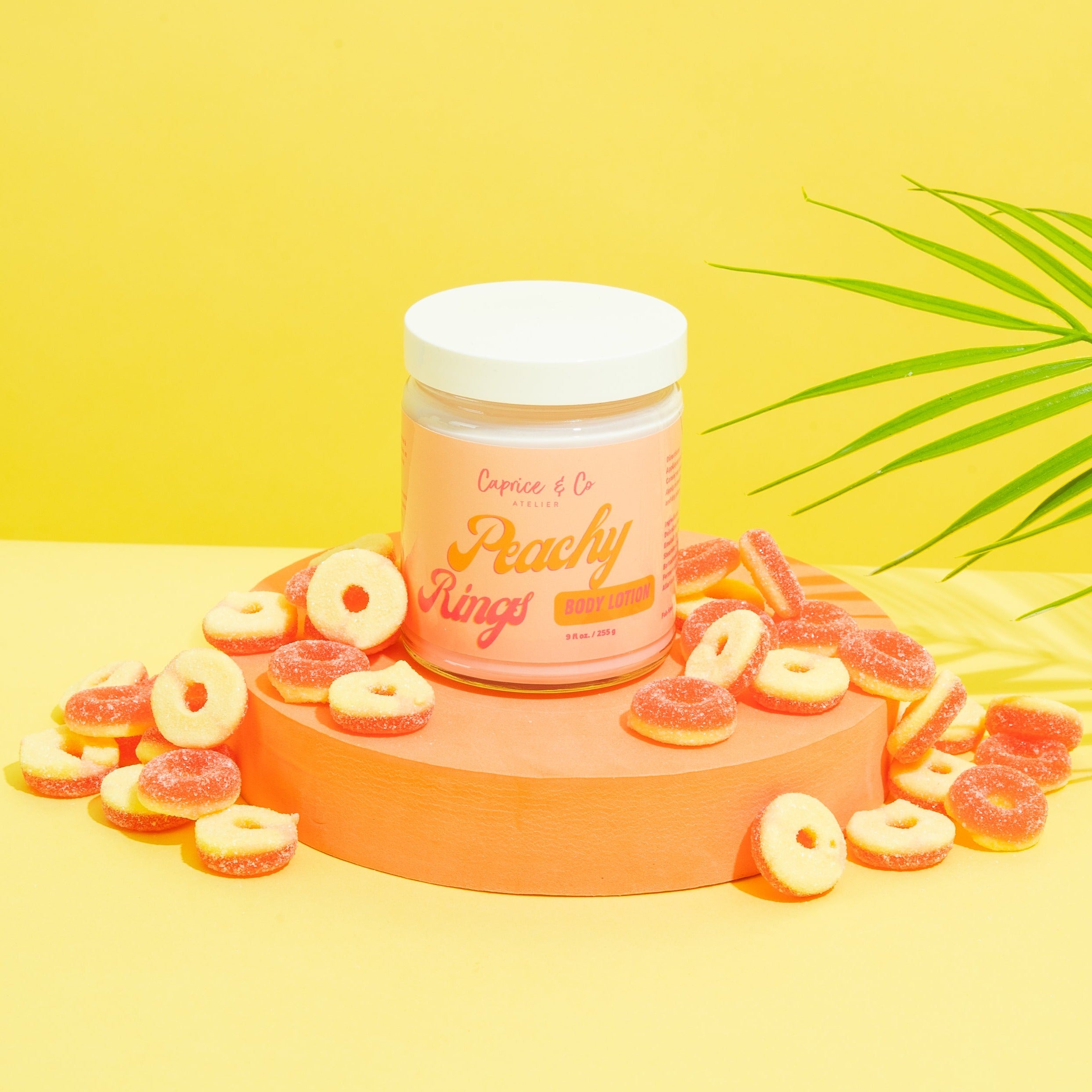 Peachy Rings Body Lotion in a glass jar with a sweet peach scent, showcasing its creamy texture and vibrant packaging.