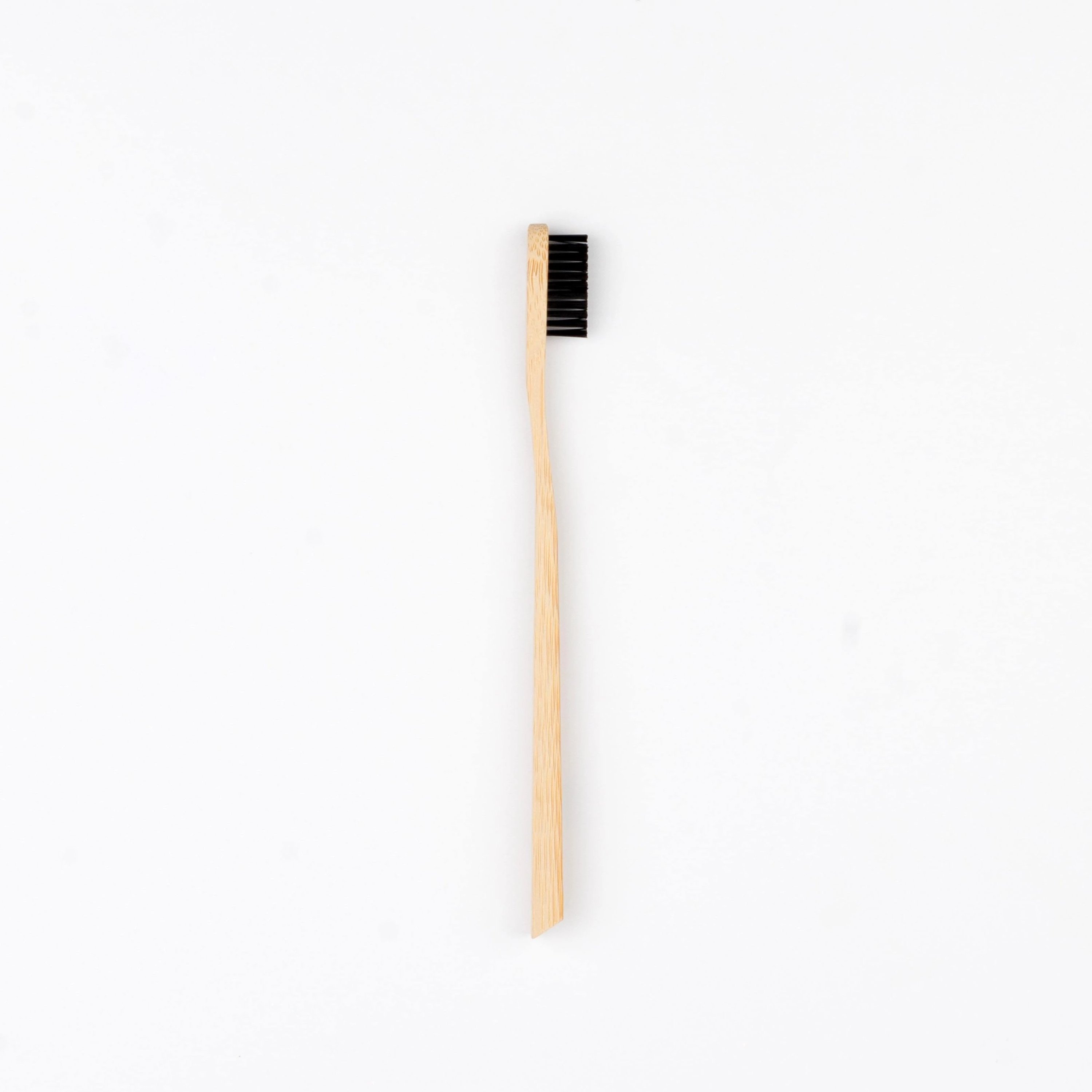 PearlBar Bamboo & Charcoal Toothbrush with a bamboo handle and charcoal-infused bristles, showcasing its eco-friendly design.