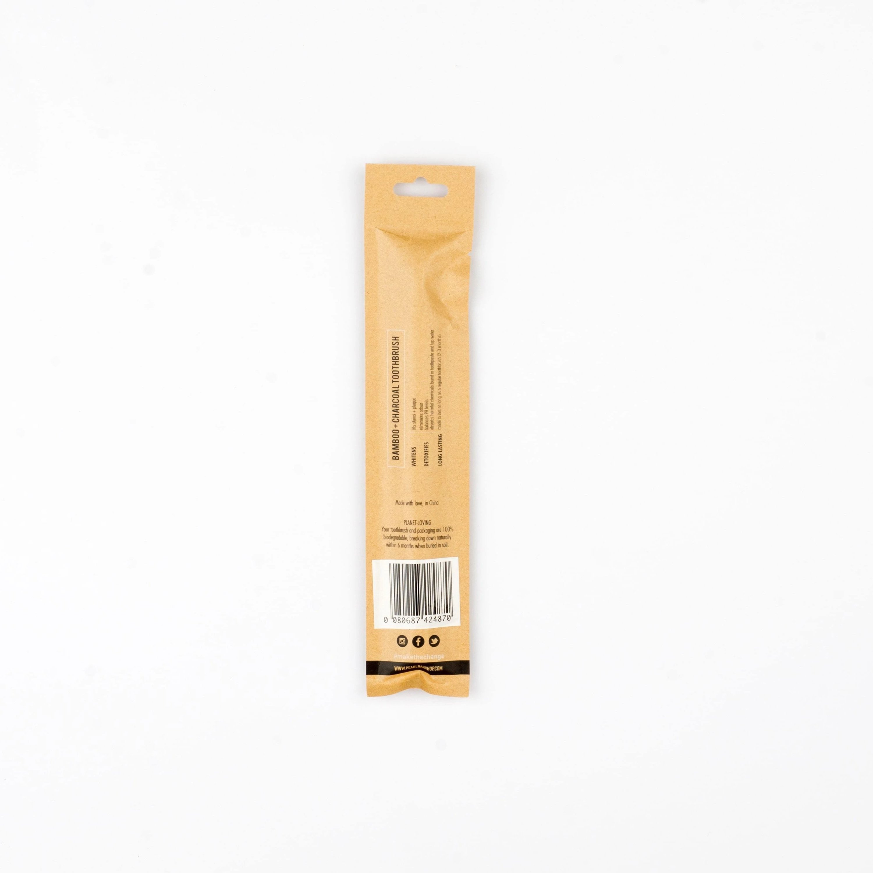 PearlBar Bamboo & Charcoal Toothbrush with a bamboo handle and charcoal-infused bristles, showcasing its eco-friendly design.