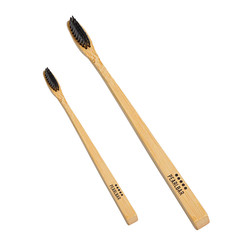 PearlBar Bamboo & Charcoal Toothbrush with a bamboo handle and charcoal-infused bristles, showcasing its eco-friendly design.