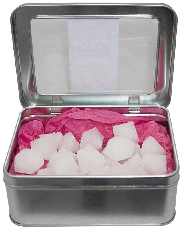 A tin of FuzeBody pH Balancing Bath Crystals with crystals and pH test strips, designed for feminine comfort and skin health.