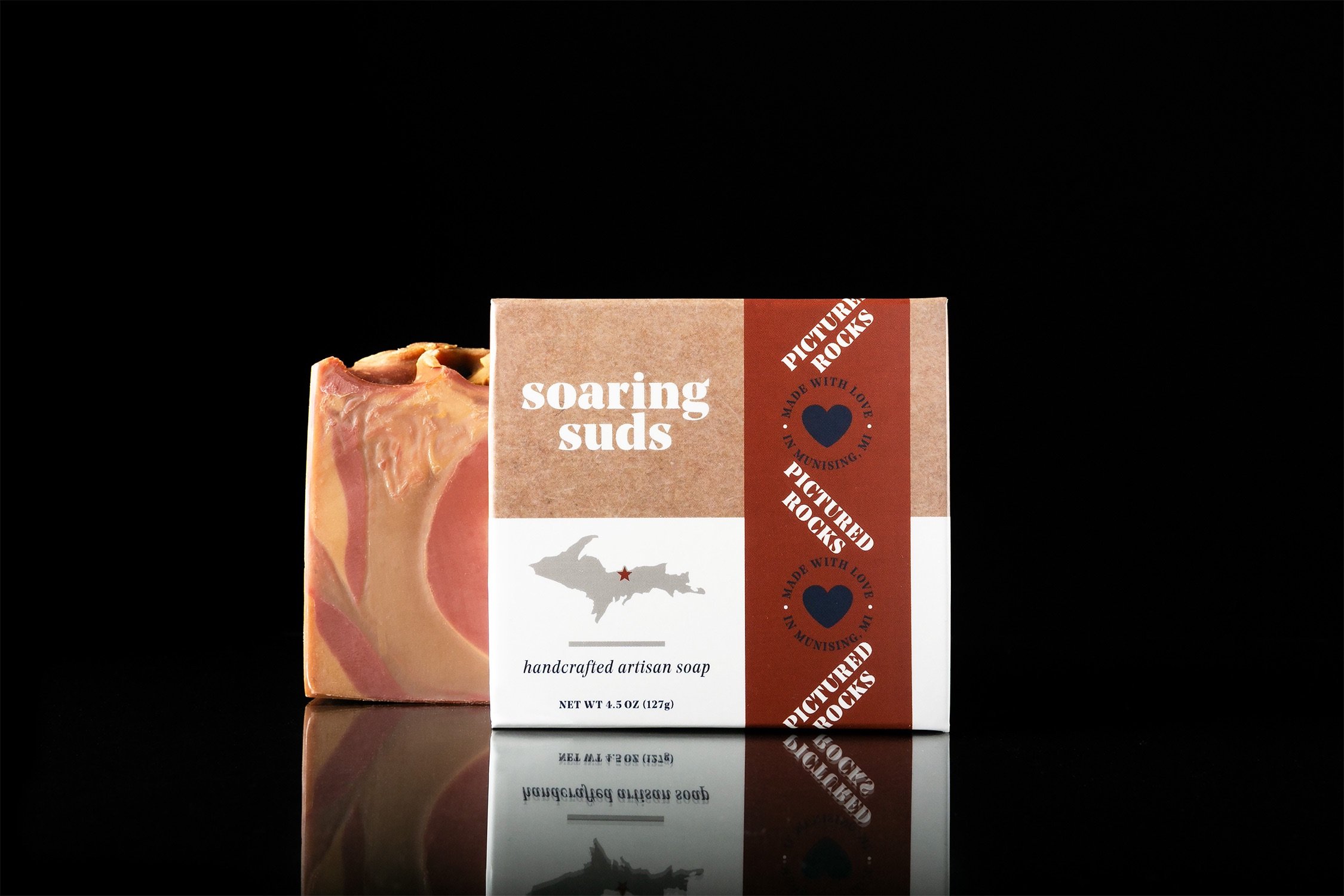 Pictured Rocks Soap bar showcasing its unique colors and textures, featuring a blend of calamondin and kumquat scents.