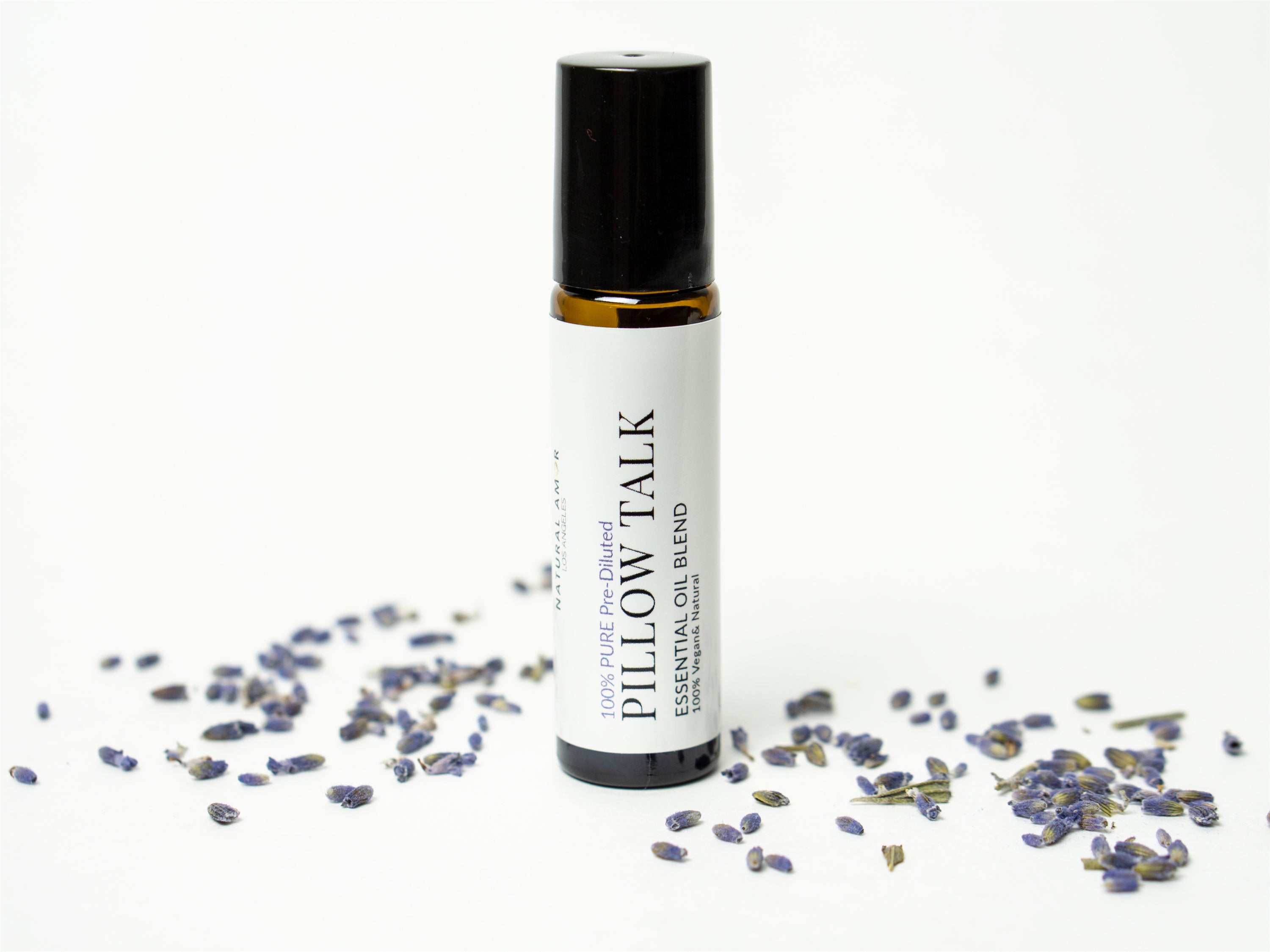 Pillow Talk Roll On Essential Oil Blend in a 10 mL bottle with a stainless steel rollerball, featuring a calming lavender and woodsy design.