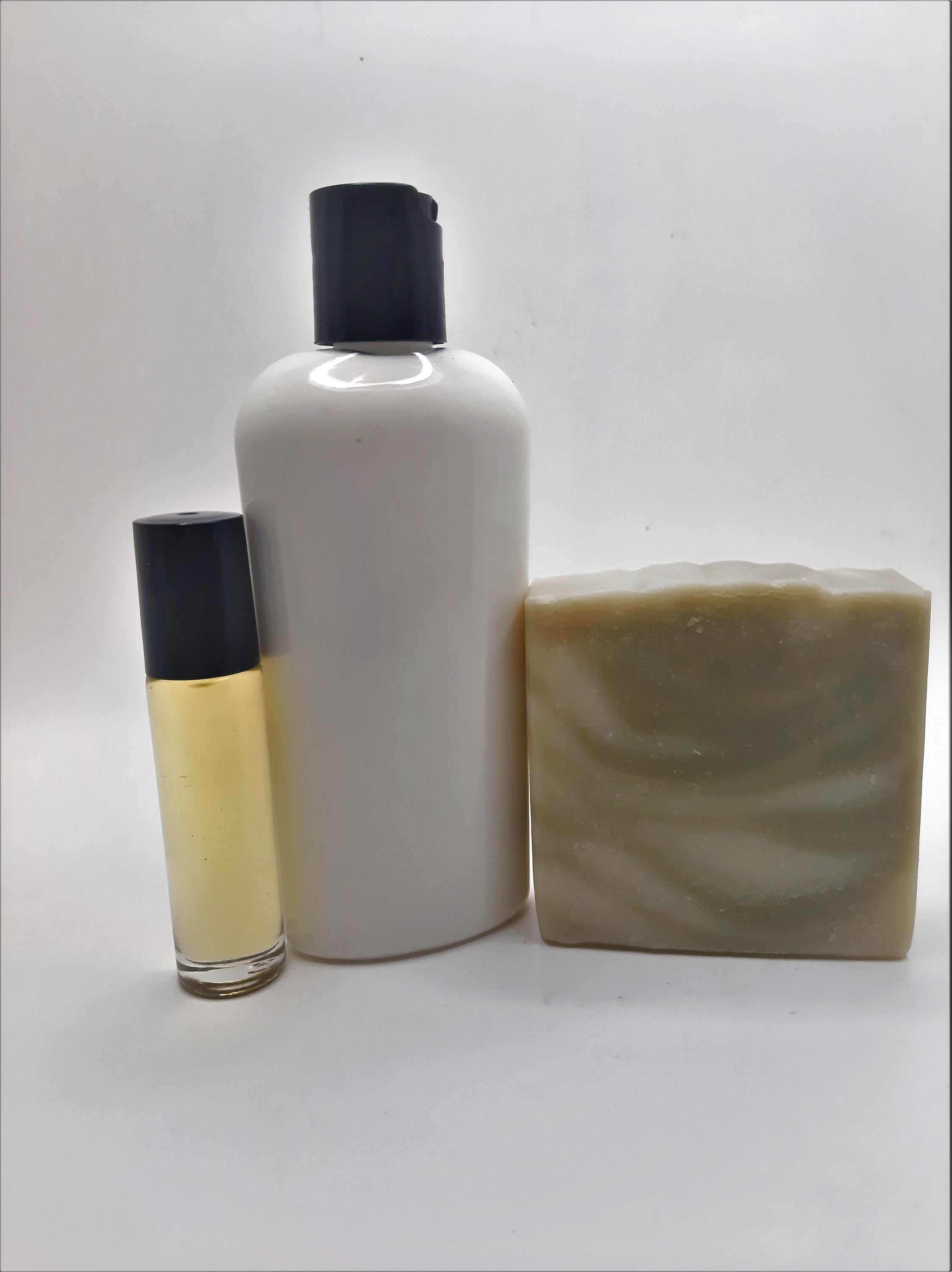 Pine Woods Gift Set featuring handmade soap, lotion, and rollerball with a refreshing pine and citrus scent.