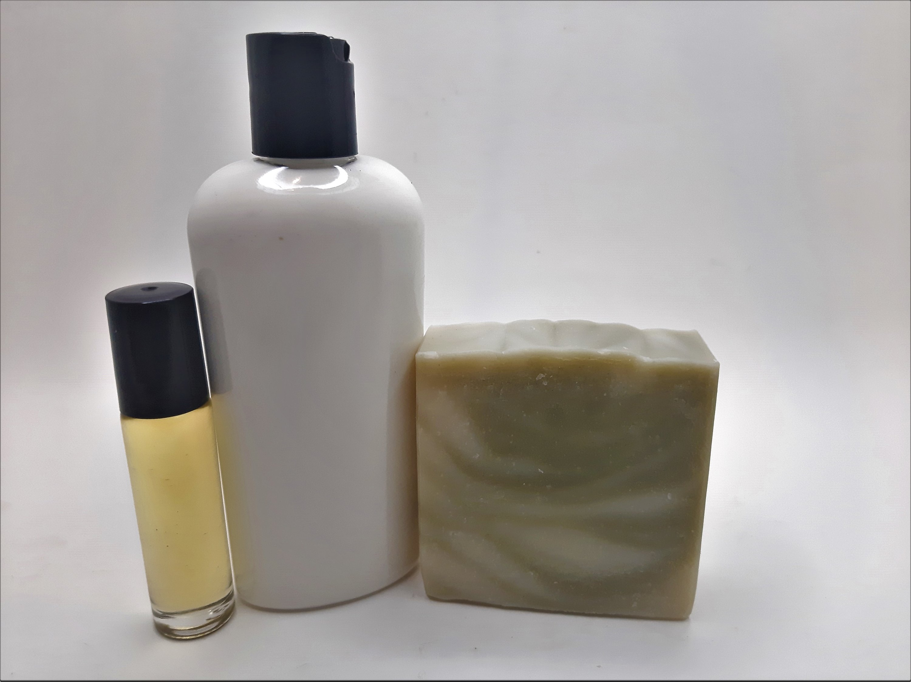 Pine Woods Gift Set featuring handmade soap, lotion, and rollerball with a refreshing pine and citrus scent.