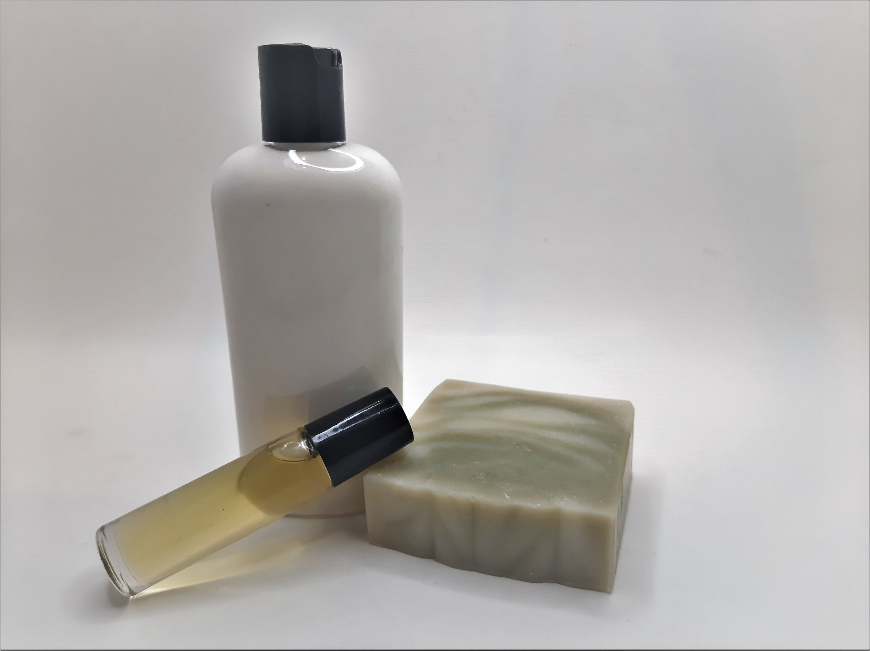 Pine Woods Gift Set featuring handmade soap, lotion, and rollerball with a refreshing pine and citrus scent.