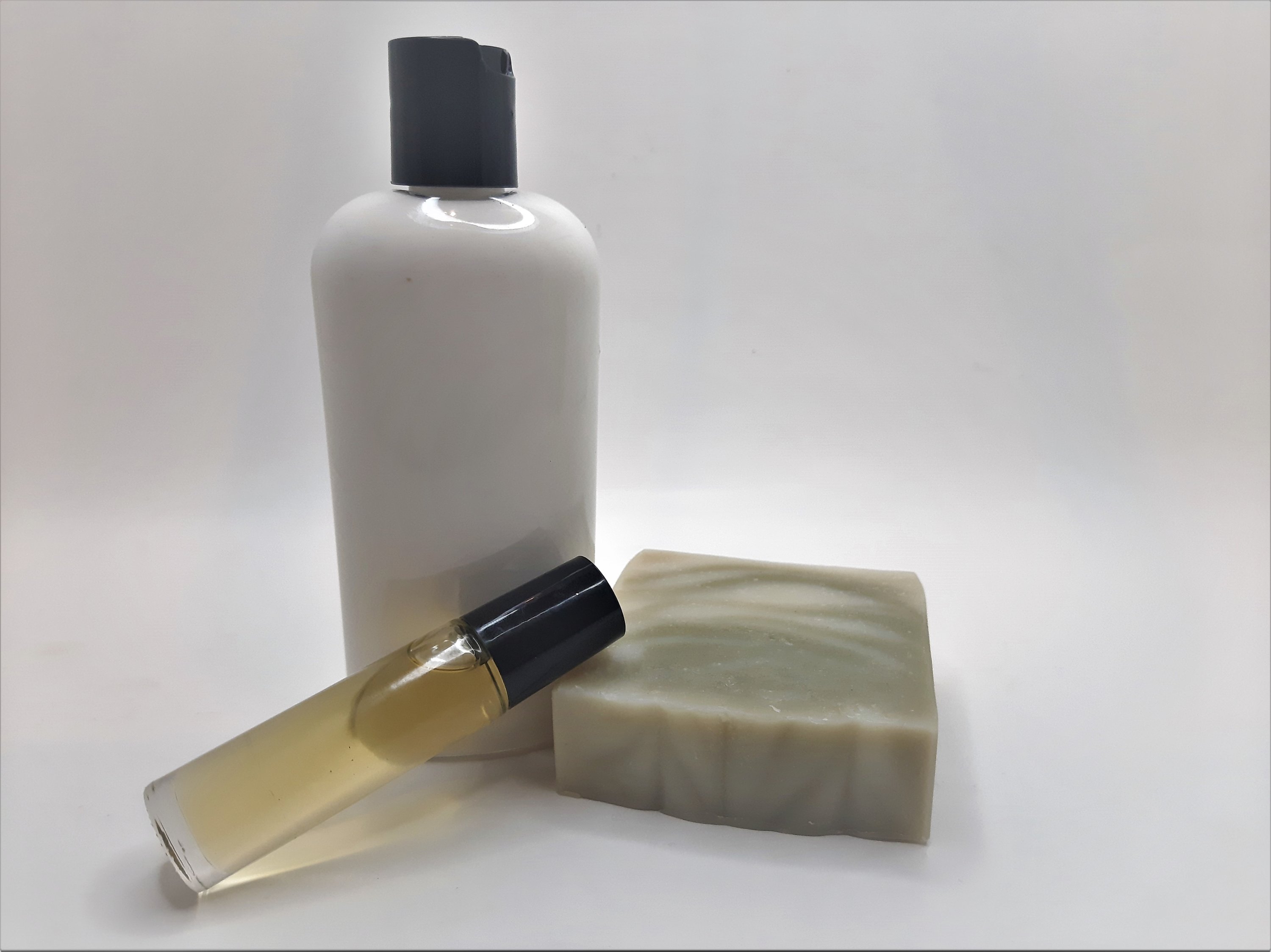 Pine Woods Gift Set featuring handmade soap, lotion, and rollerball with a refreshing pine and citrus scent.