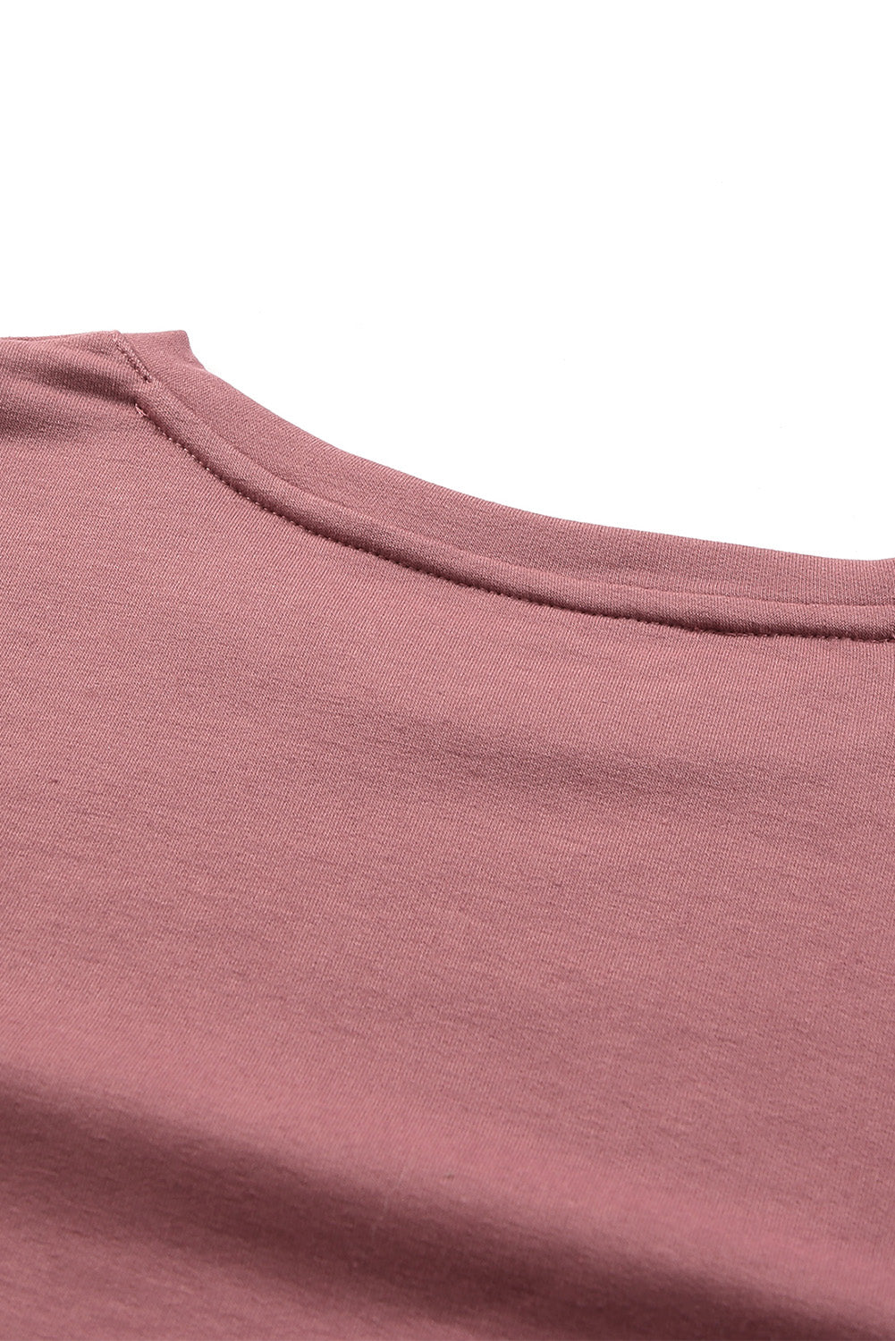 A stylish pink long sleeve crop top with banded hem and smocking cuffs, perfect for casual wear.