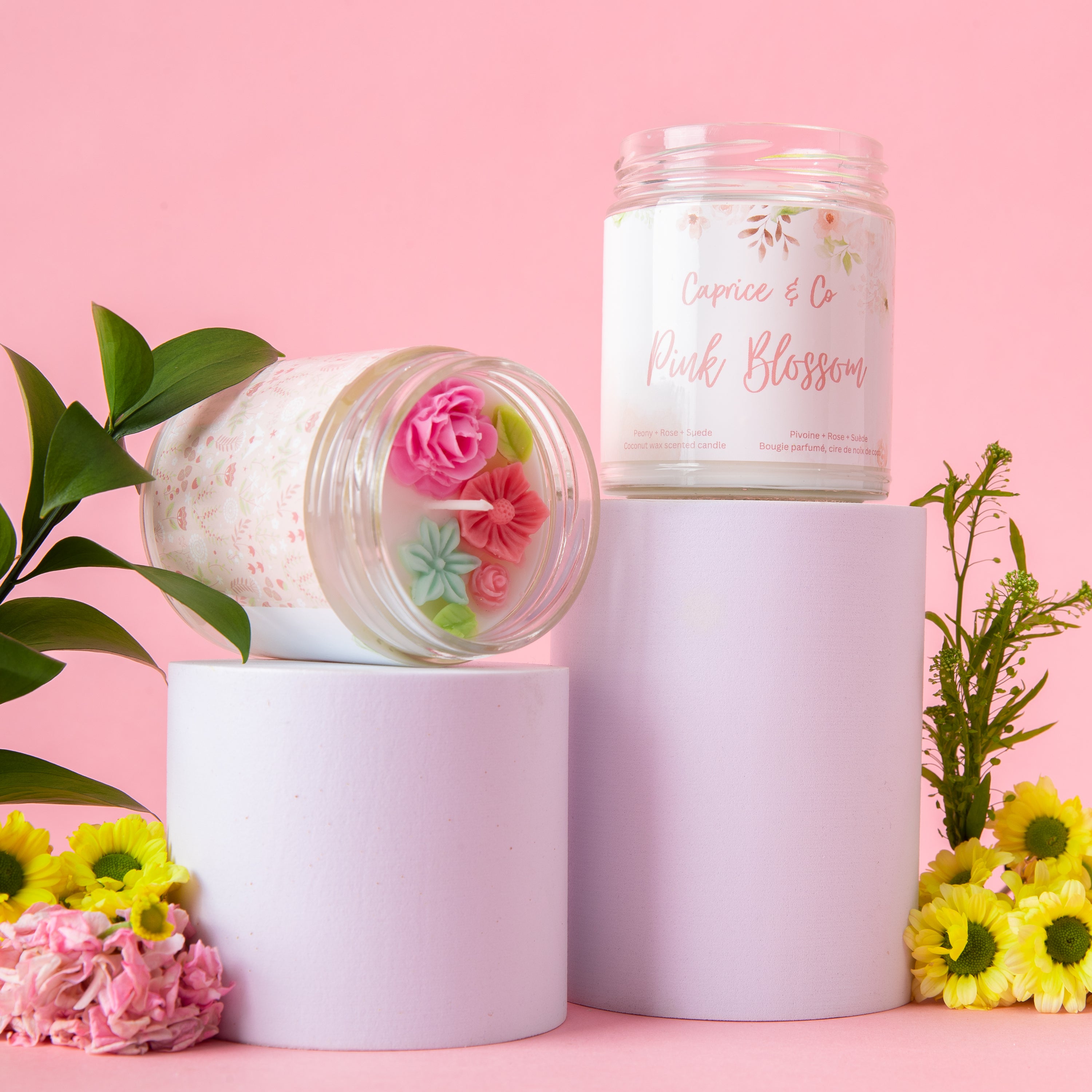 Pink Blossom Candle in a glass jar with a metal lid, featuring peony, rose, and suede scents.