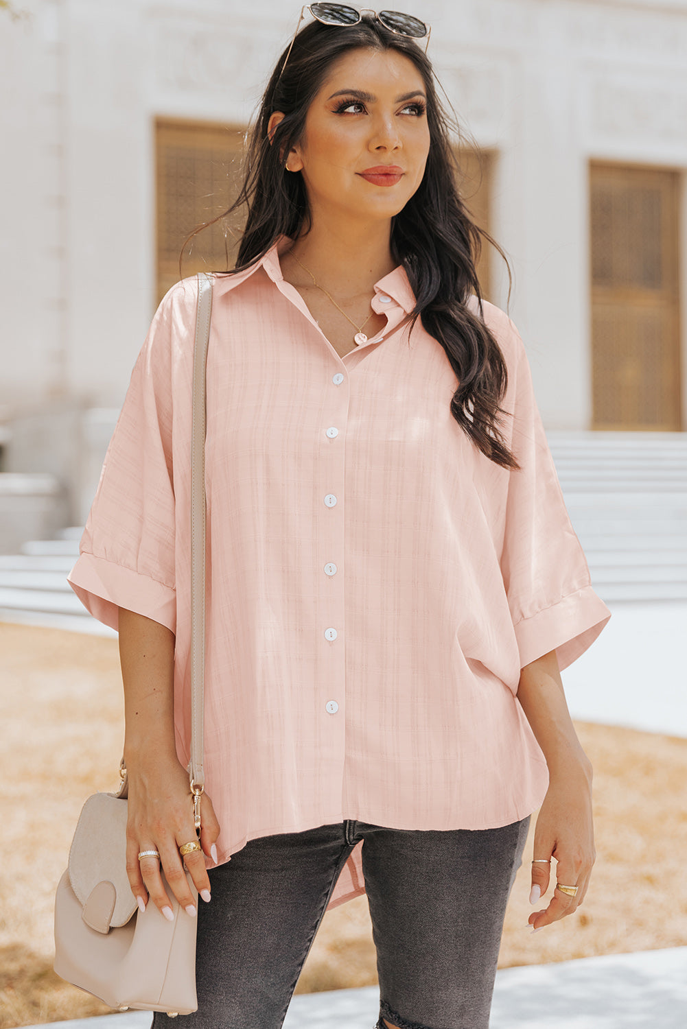 A stylish pink button front shirt with dolman sleeves, showcasing a loose fit and elegant design, perfect for casual or dressy occasions.