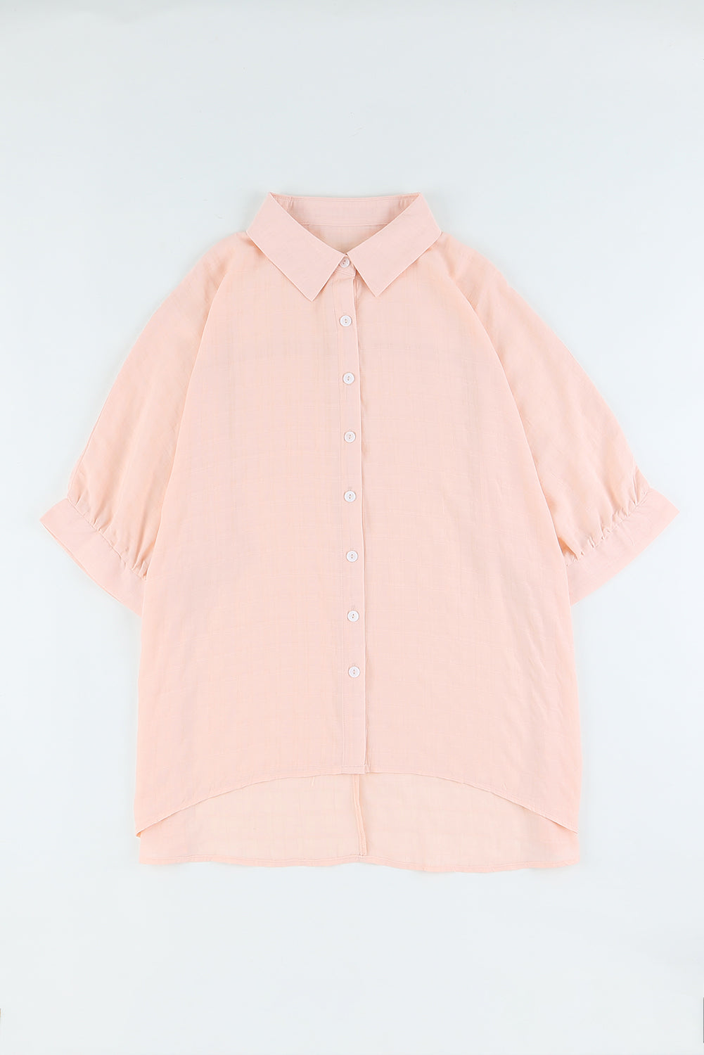 A stylish pink button front shirt with dolman sleeves, showcasing a loose fit and elegant design, perfect for casual or dressy occasions.