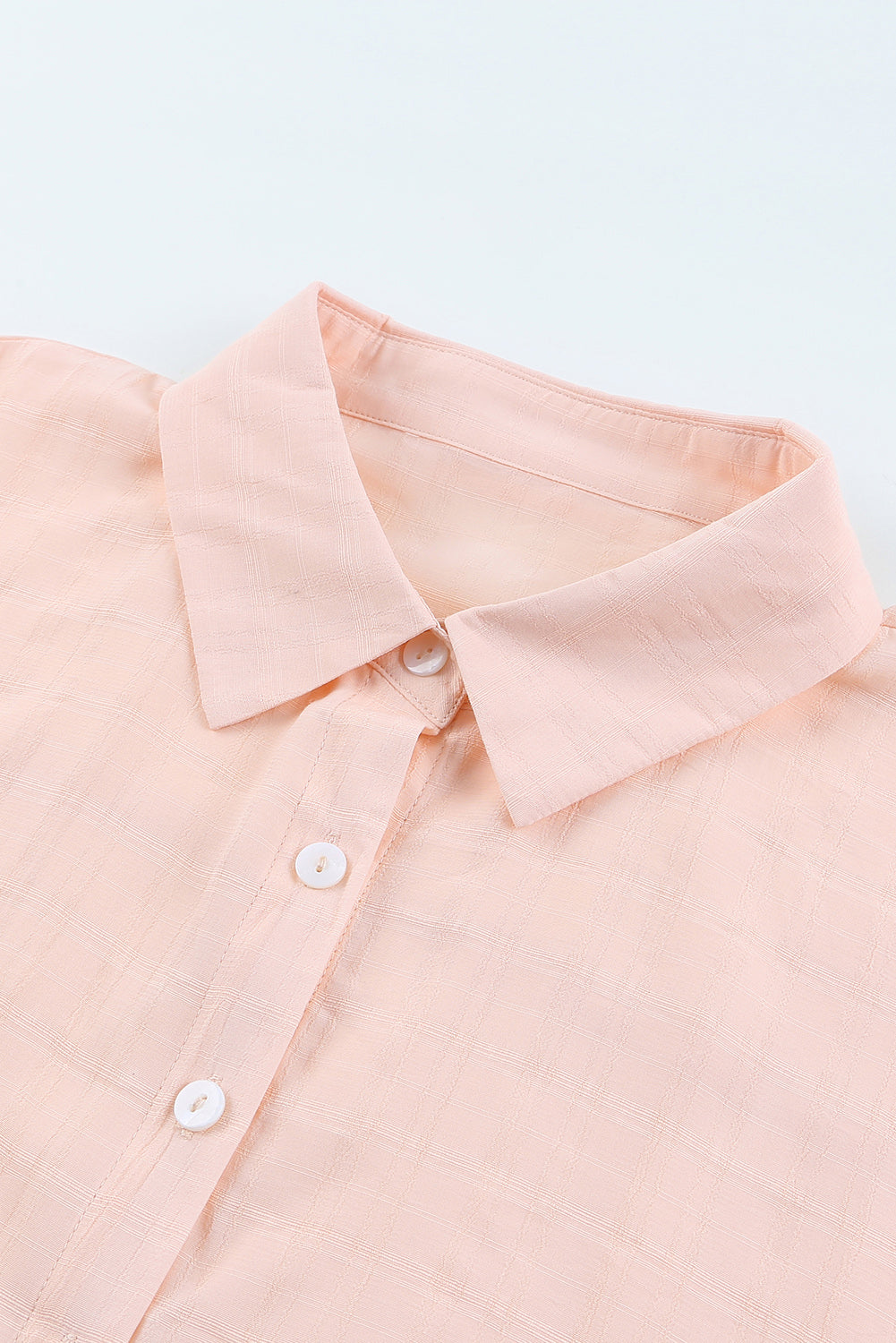 A stylish pink button front shirt with dolman sleeves, showcasing a loose fit and elegant design, perfect for casual or dressy occasions.