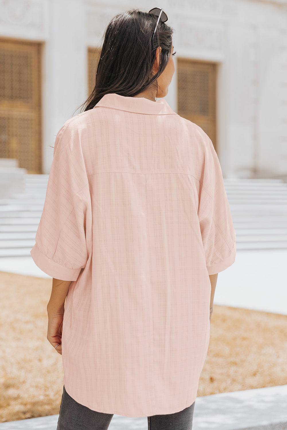 A stylish pink button front shirt with dolman sleeves, showcasing a loose fit and elegant design, perfect for casual or dressy occasions.