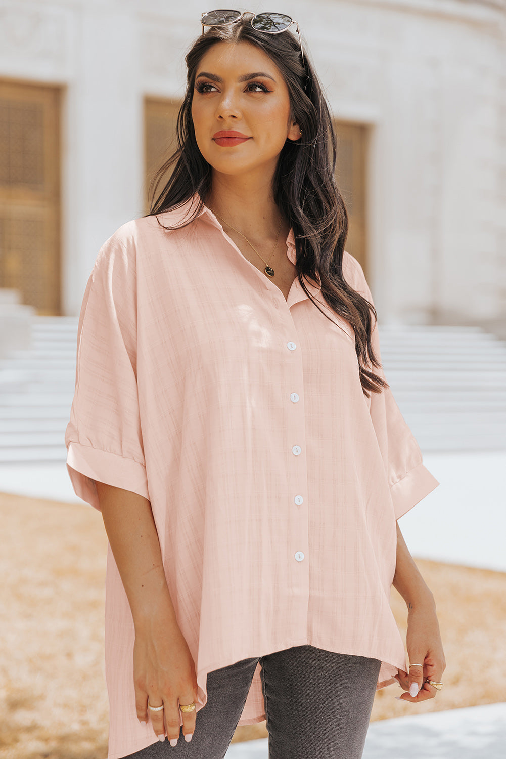 A stylish pink button front shirt with dolman sleeves, showcasing a loose fit and elegant design, perfect for casual or dressy occasions.