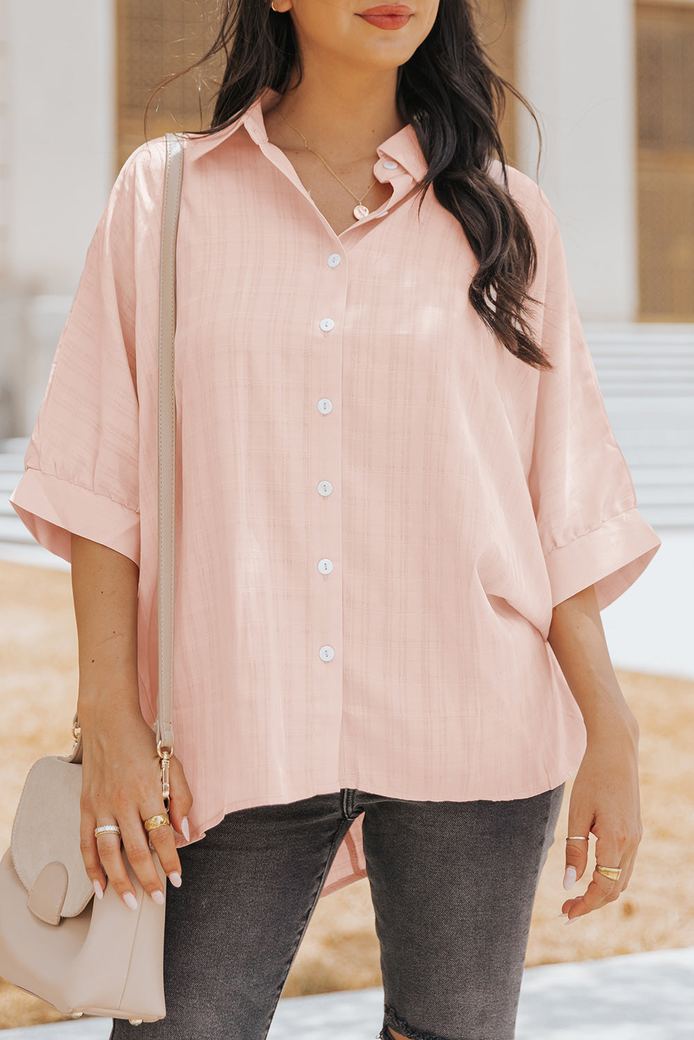 A stylish pink button front shirt with dolman sleeves, showcasing a loose fit and elegant design, perfect for casual or dressy occasions.