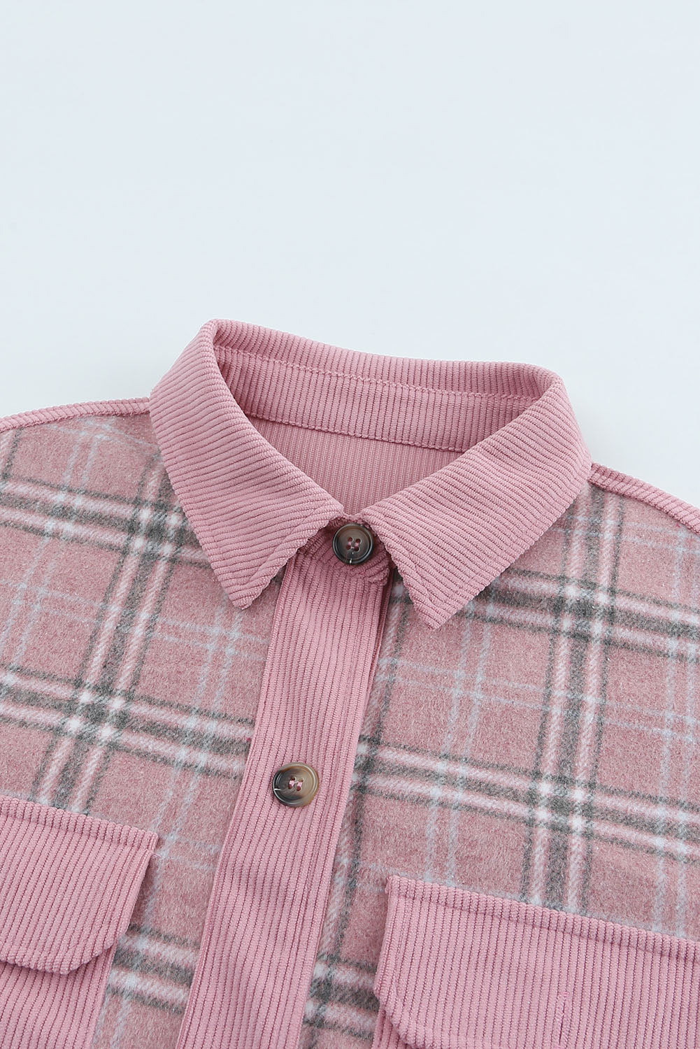 A stylish pink corduroy shacket with plaid pattern, featuring a turn-down collar, chest pockets, and button closure, perfect for casual wear.