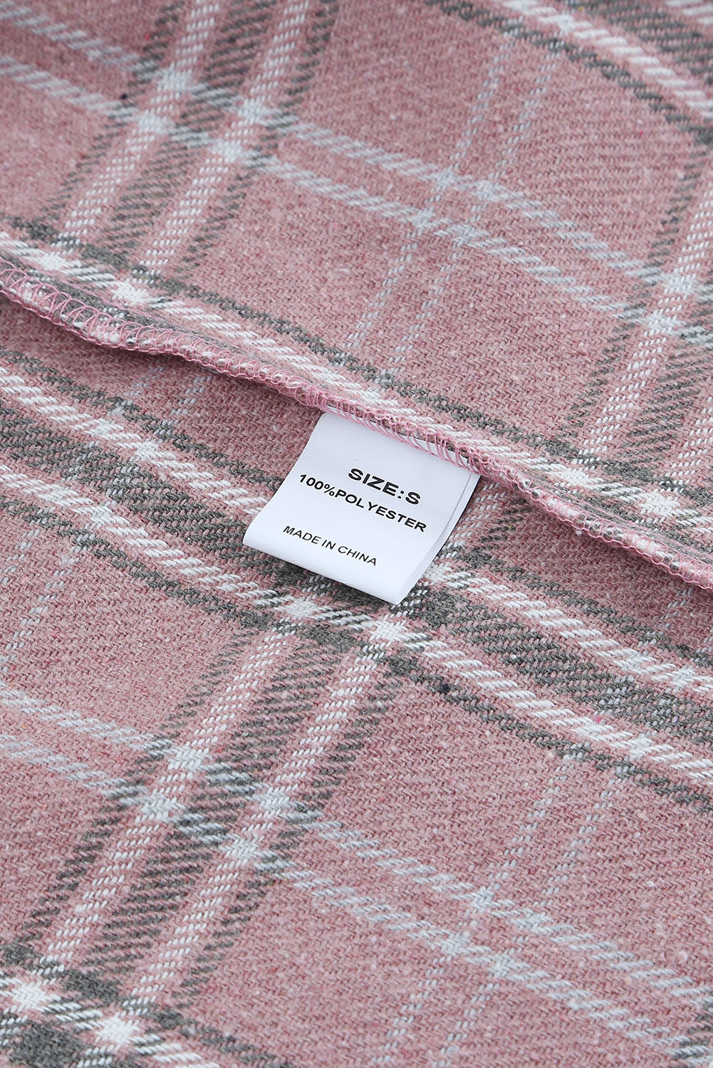 A stylish pink corduroy shacket with plaid pattern, featuring a turn-down collar, chest pockets, and button closure, perfect for casual wear.