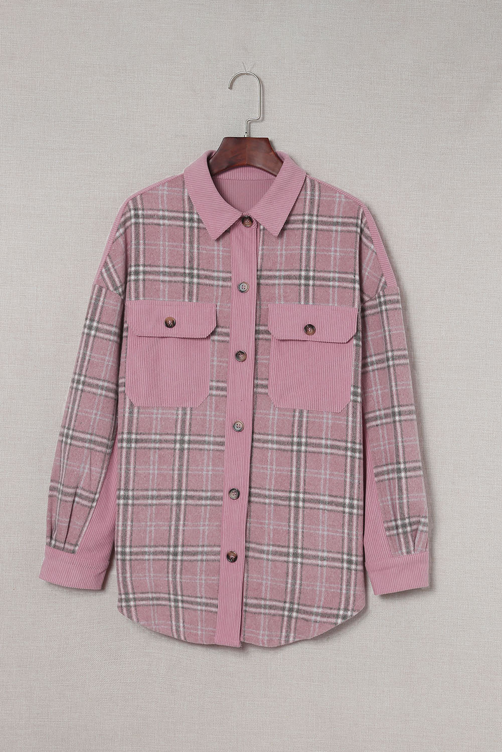 A stylish pink corduroy shacket with plaid pattern, featuring a turn-down collar, chest pockets, and button closure, perfect for casual wear.