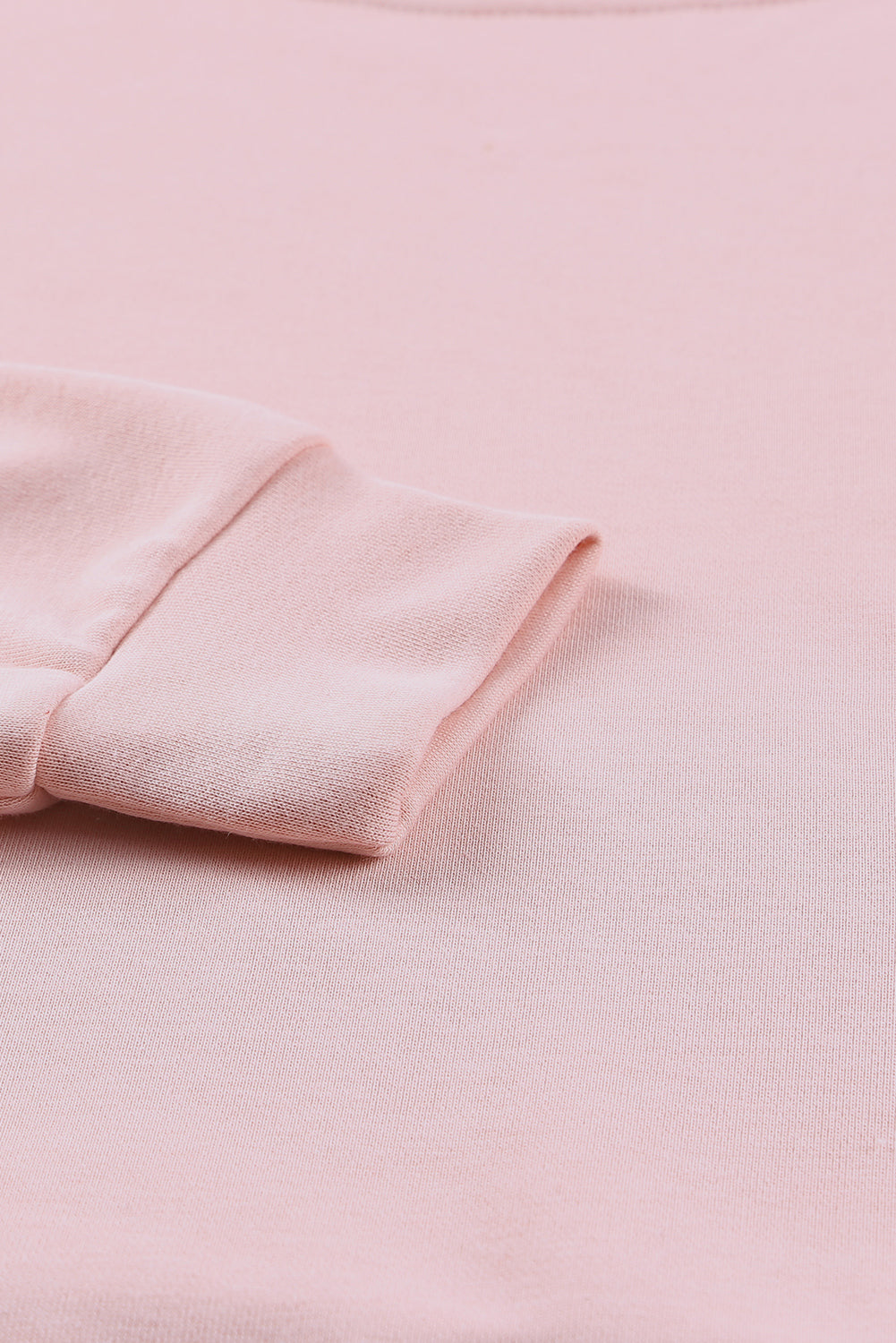 A stylish pink crew neck sweatshirt featuring slit buttons, designed for comfort and a relaxed fit, suitable for all body types.