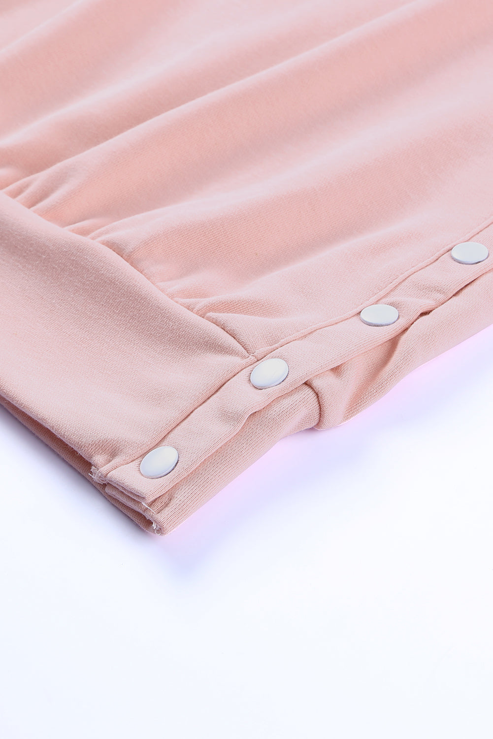 A stylish pink crew neck sweatshirt featuring slit buttons, designed for comfort and a relaxed fit, suitable for all body types.