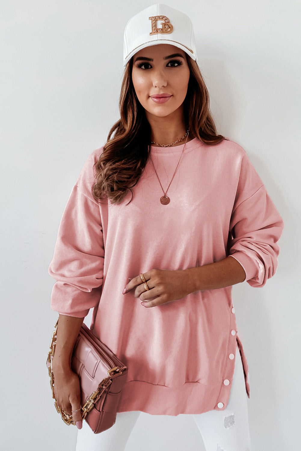 A stylish pink crew neck sweatshirt featuring slit buttons, designed for comfort and a relaxed fit, suitable for all body types.