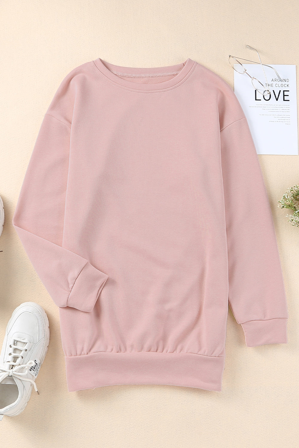 A stylish pink crew neck sweatshirt featuring slit buttons, designed for comfort and a relaxed fit, suitable for all body types.