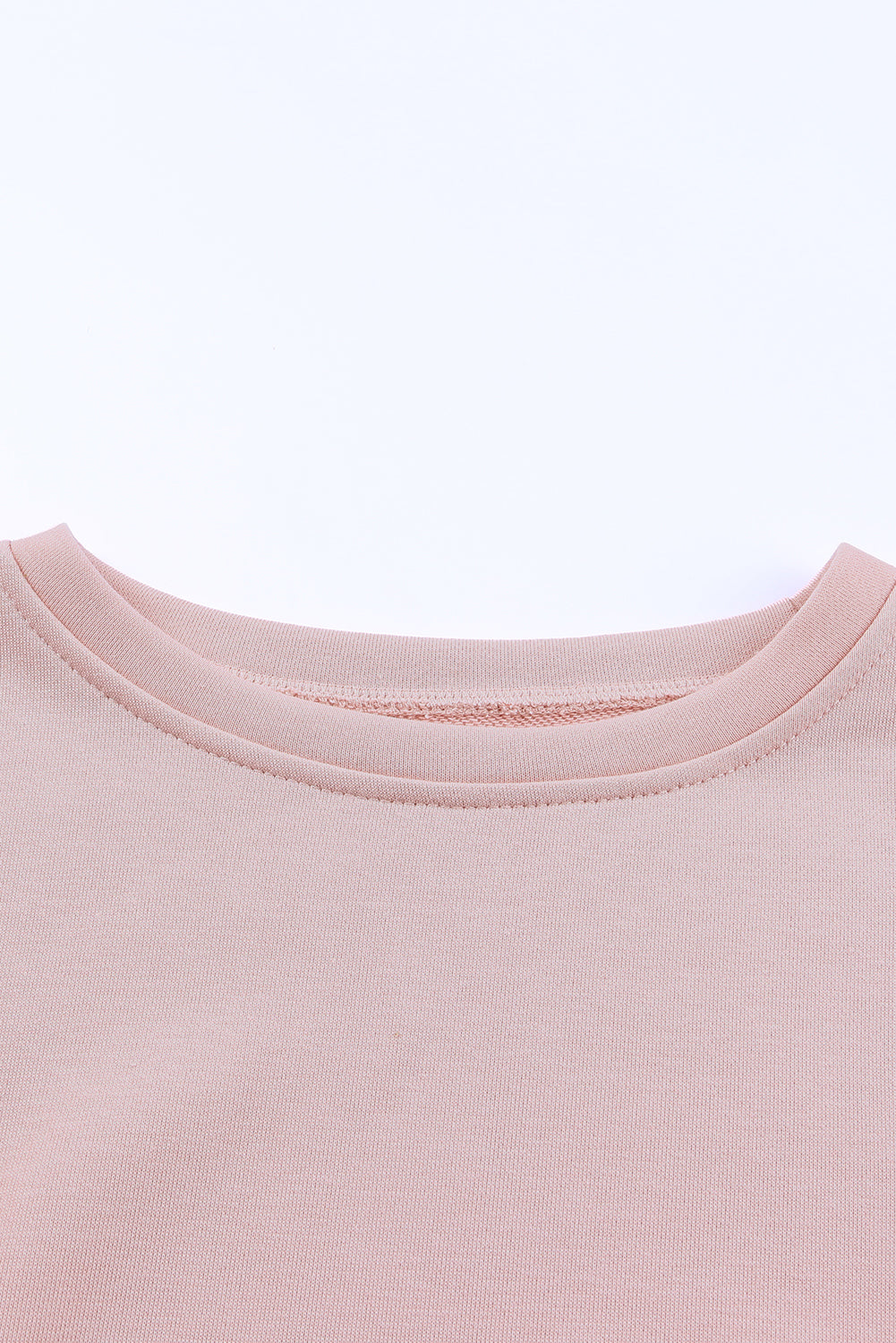 A stylish pink crew neck sweatshirt featuring slit buttons, designed for comfort and a relaxed fit, suitable for all body types.