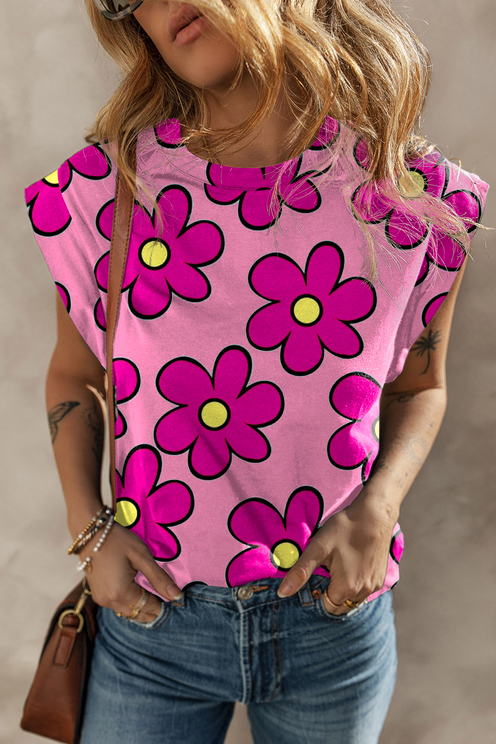 A stylish pink flower print round neck cap sleeve t-shirt displayed on a mannequin, showcasing its vibrant floral design and comfortable fit.