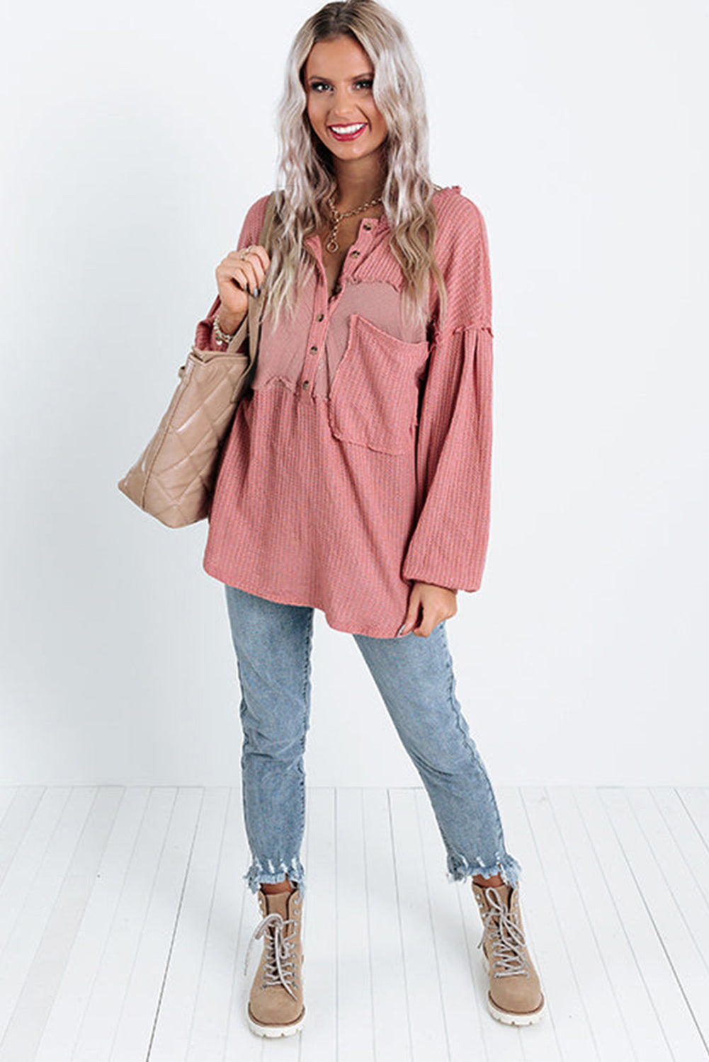 A stylish pink frayed patchwork waffle knit top featuring a buttoned neckline, drop shoulders, and a patch pocket, perfect for casual wear.