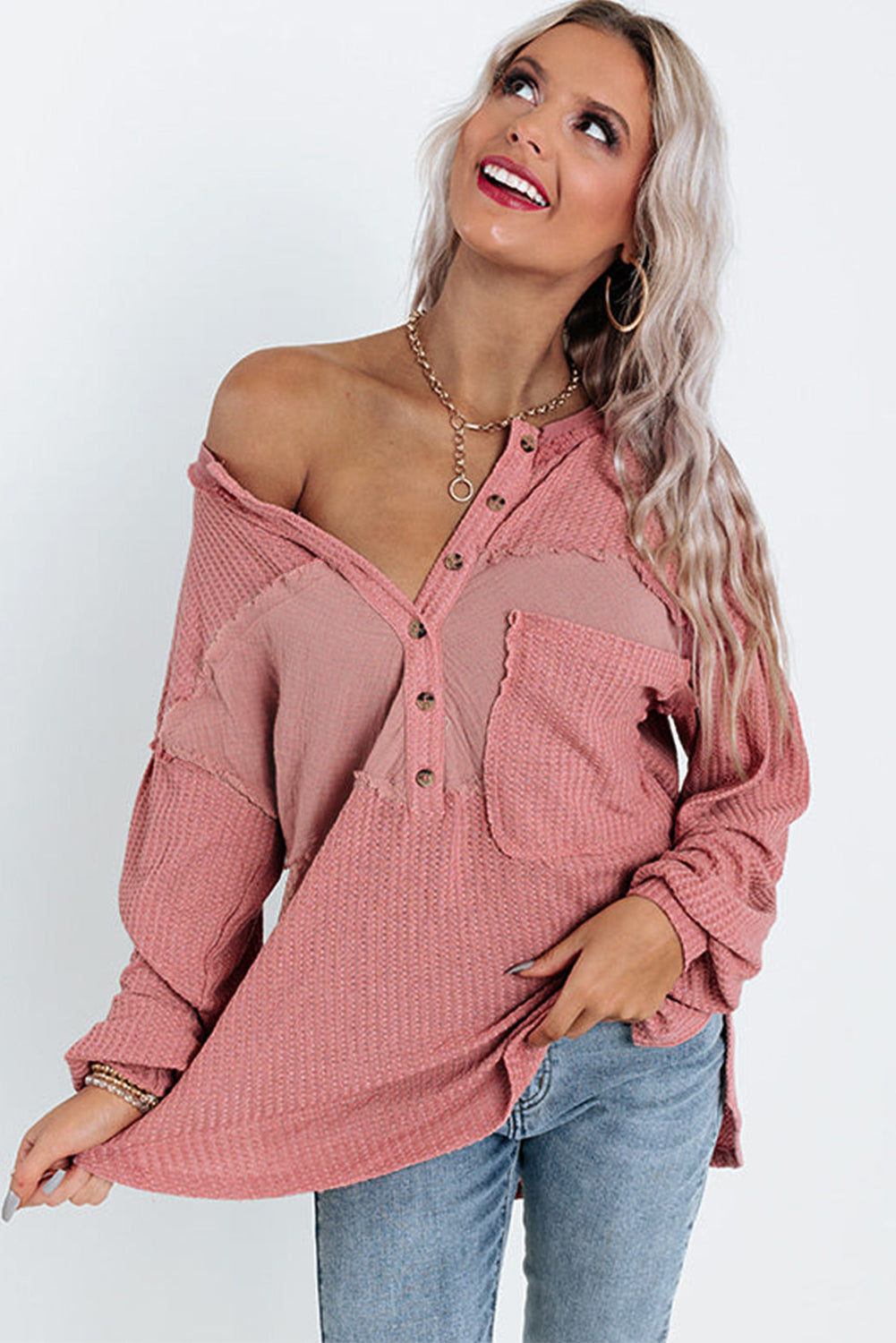 A stylish pink frayed patchwork waffle knit top featuring a buttoned neckline, drop shoulders, and a patch pocket, perfect for casual wear.