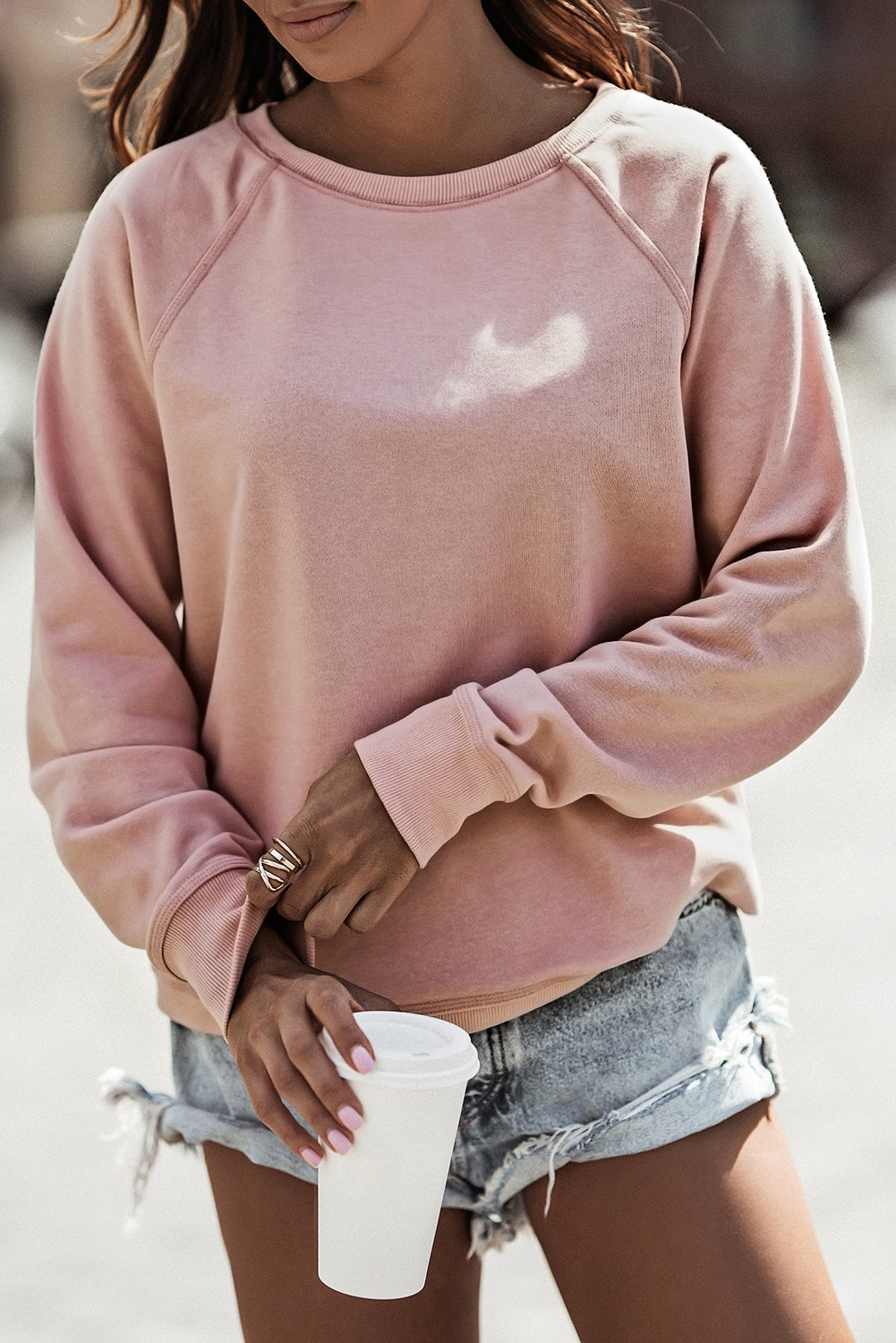 A stylish pink French terry cotton blend pullover sweatshirt featuring a crew neckline, long sleeves, and distressed detailing for a relaxed look.