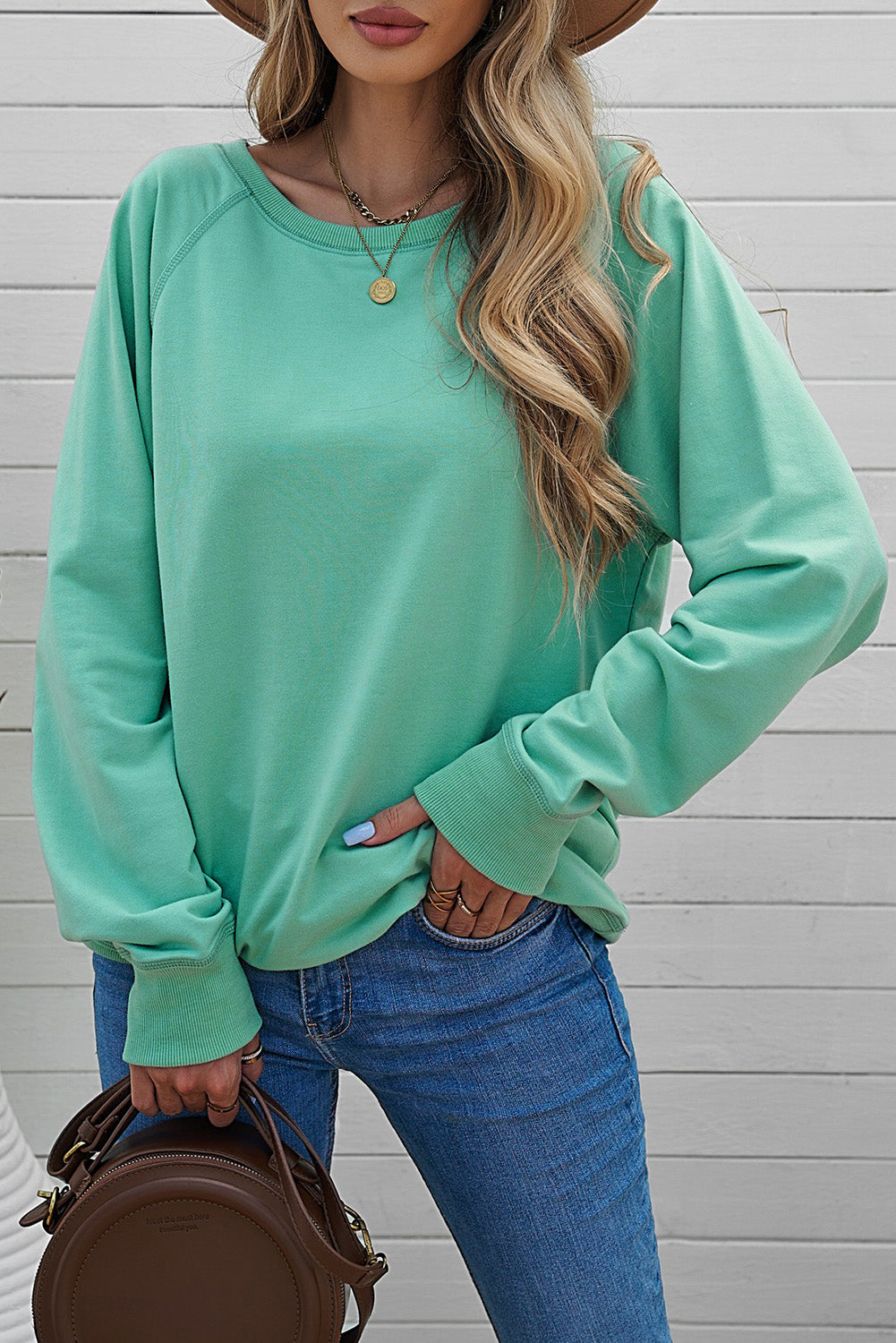 A stylish pink French terry cotton blend pullover sweatshirt featuring a crew neckline, long sleeves, and distressed detailing for a relaxed look.