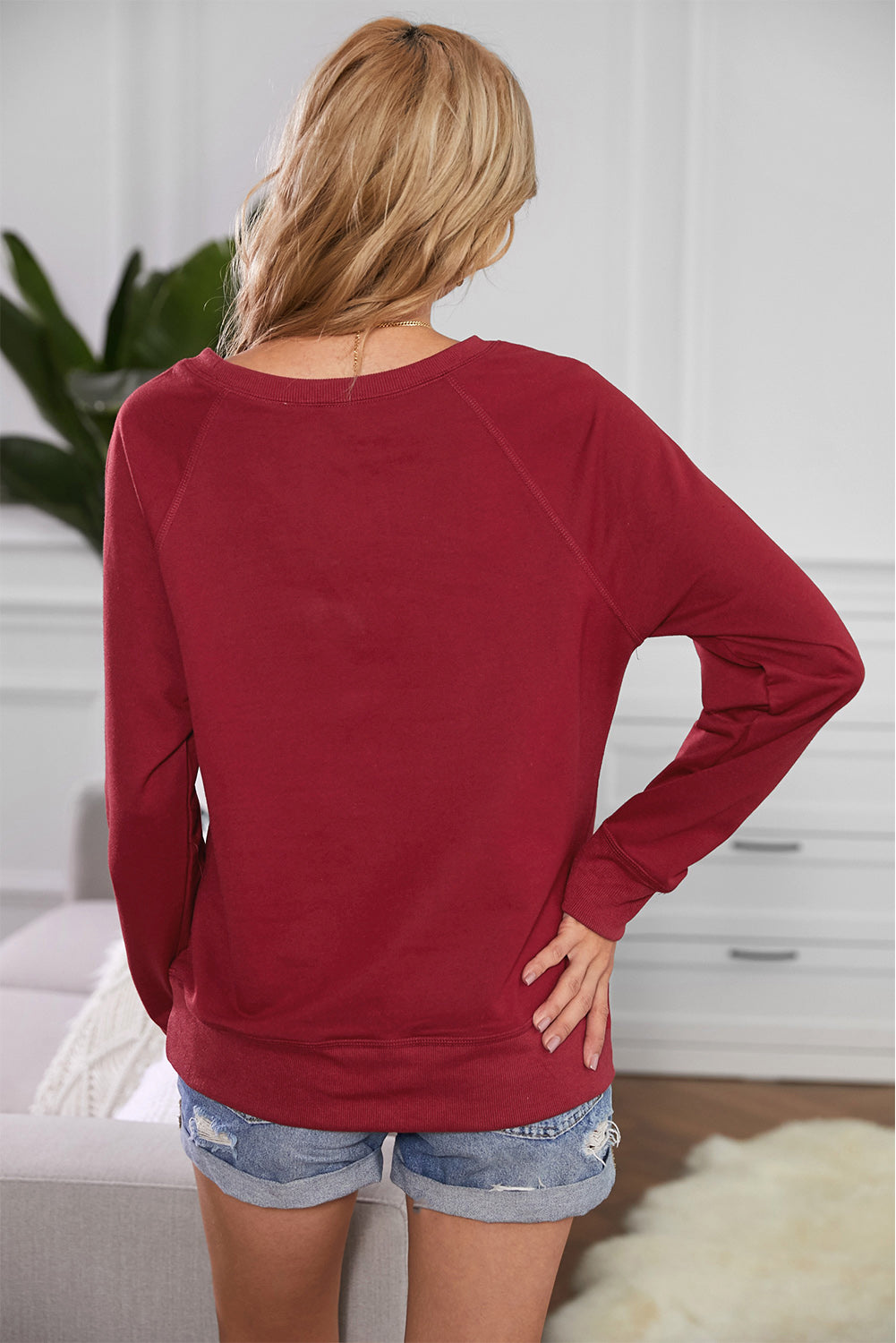 A stylish pink French terry cotton blend pullover sweatshirt featuring a crew neckline, long sleeves, and distressed detailing for a relaxed look.