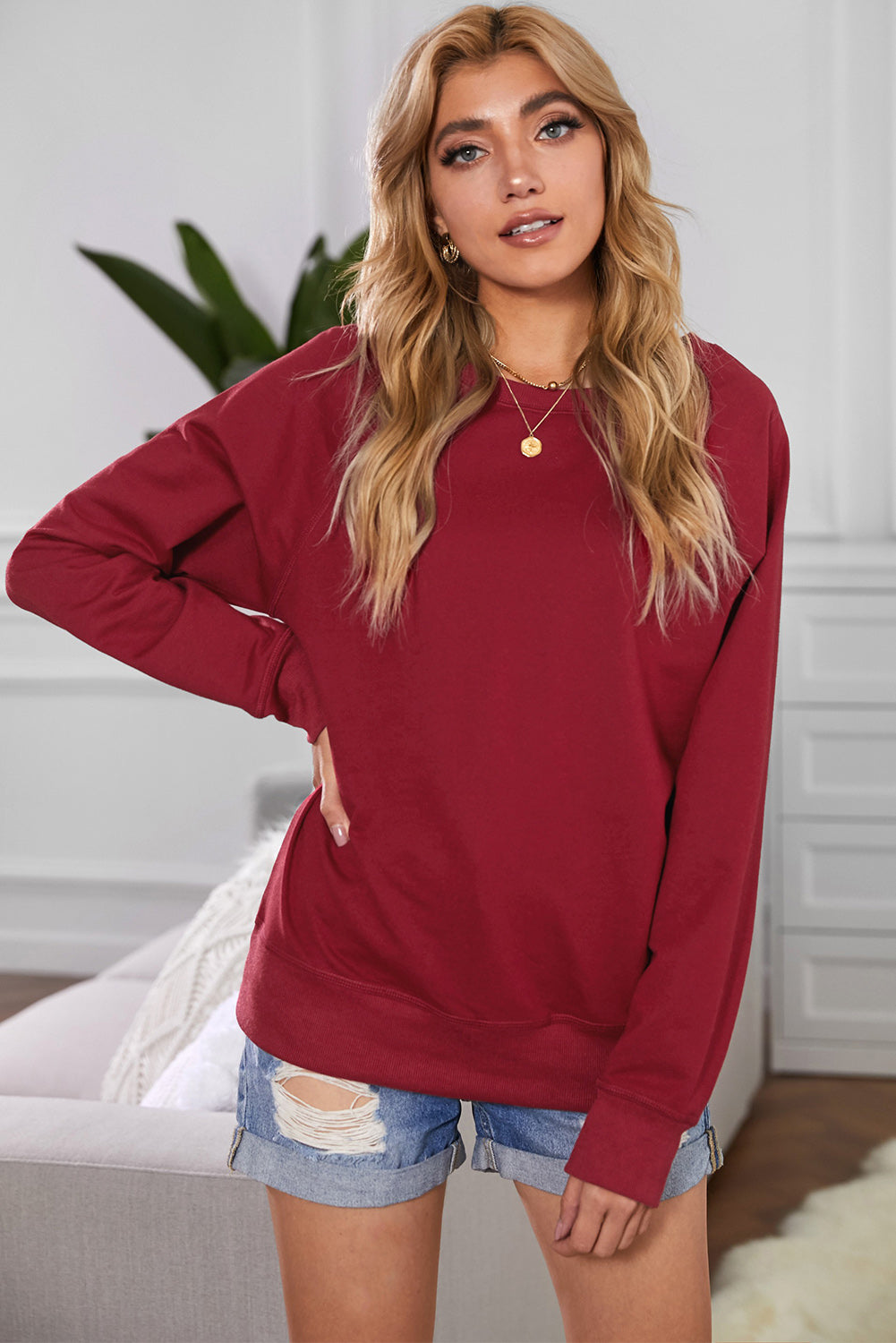 A stylish pink French terry cotton blend pullover sweatshirt featuring a crew neckline, long sleeves, and distressed detailing for a relaxed look.