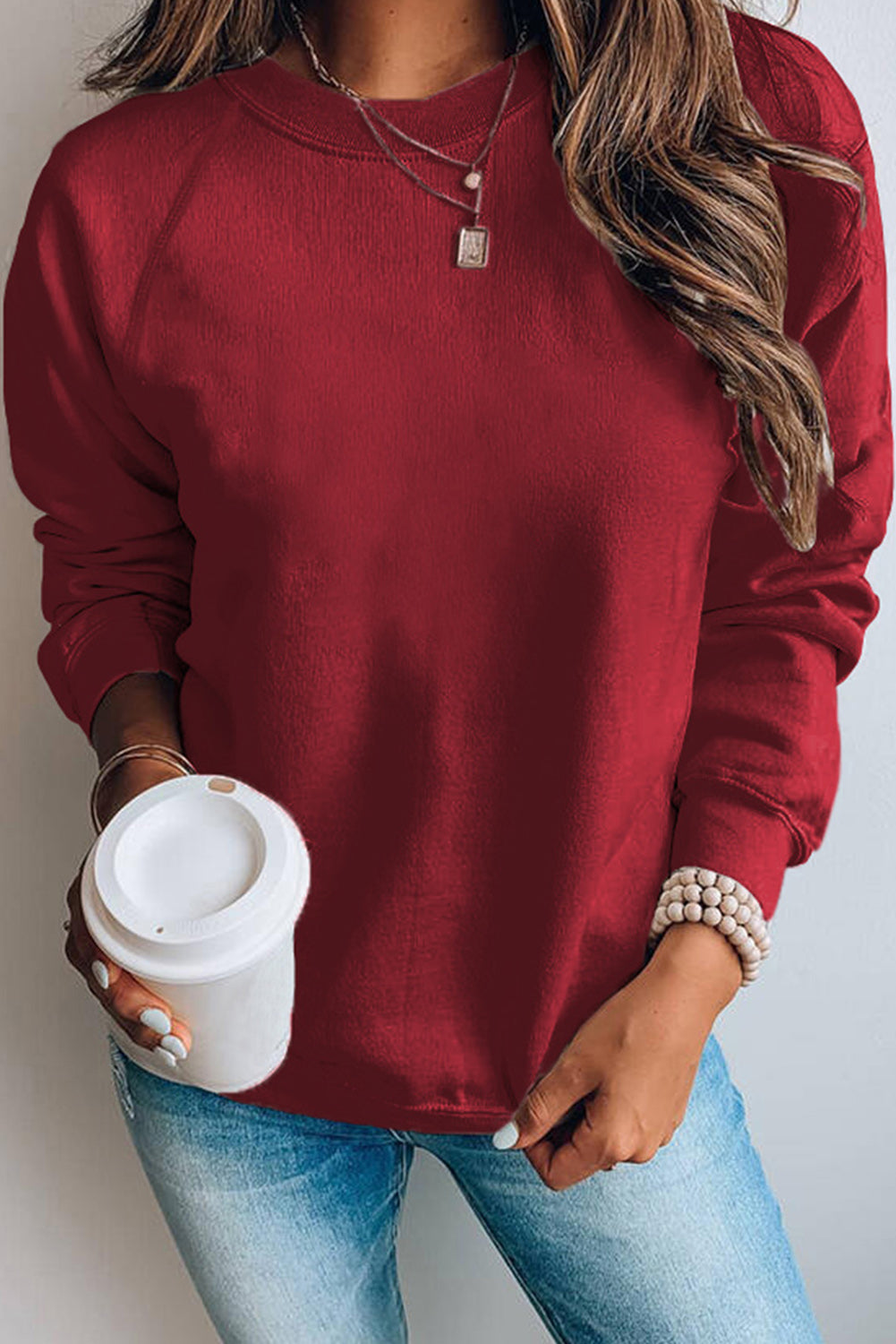 A stylish pink French terry cotton blend pullover sweatshirt featuring a crew neckline, long sleeves, and distressed detailing for a relaxed look.