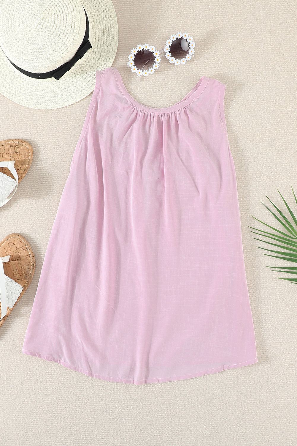 A stylish pink hollow-out tank top showcasing a unique cutout design, perfect for casual and formal occasions.