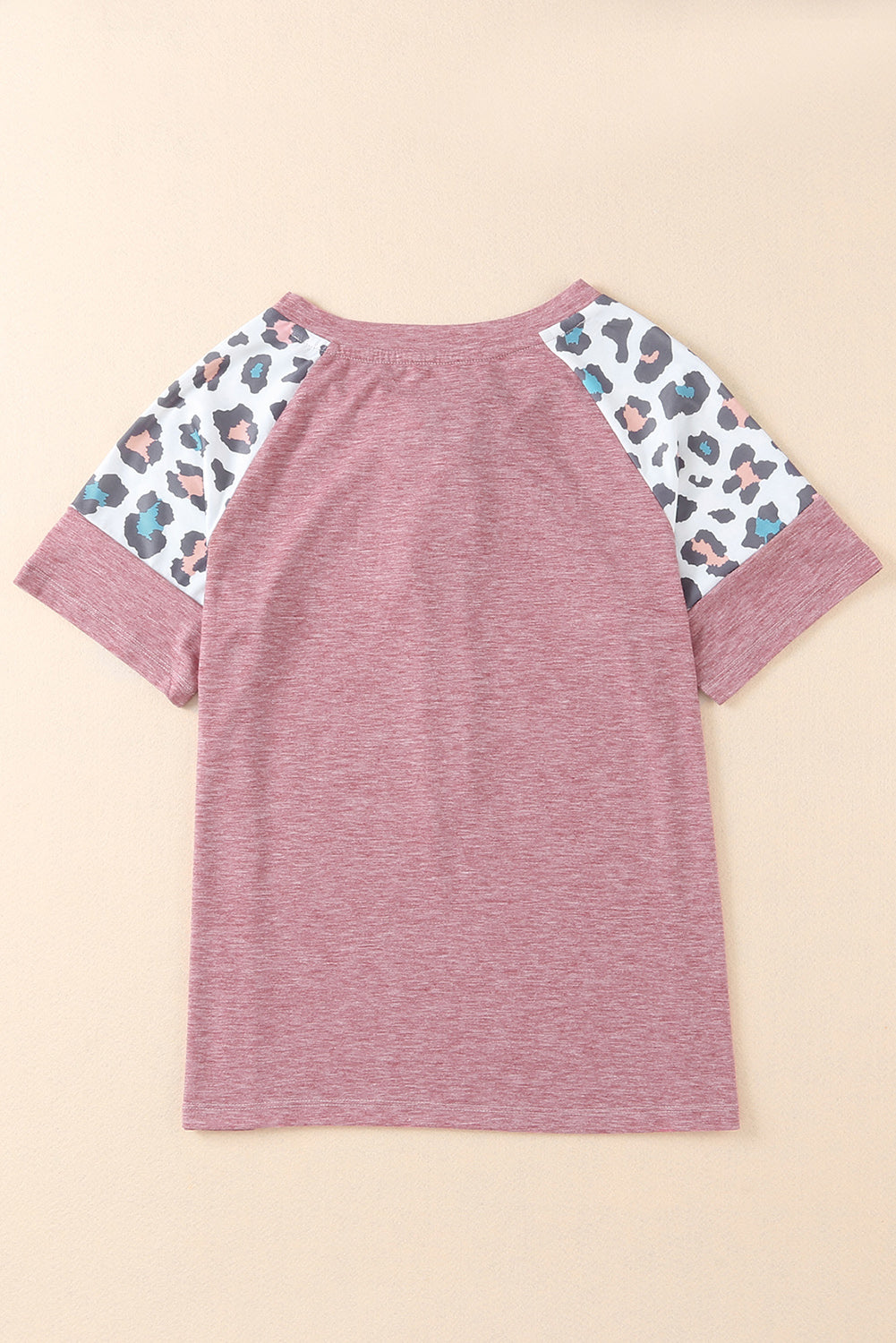 A stylish pink t-shirt featuring lace-up detail and leopard print raglan sleeves, perfect for casual wear.