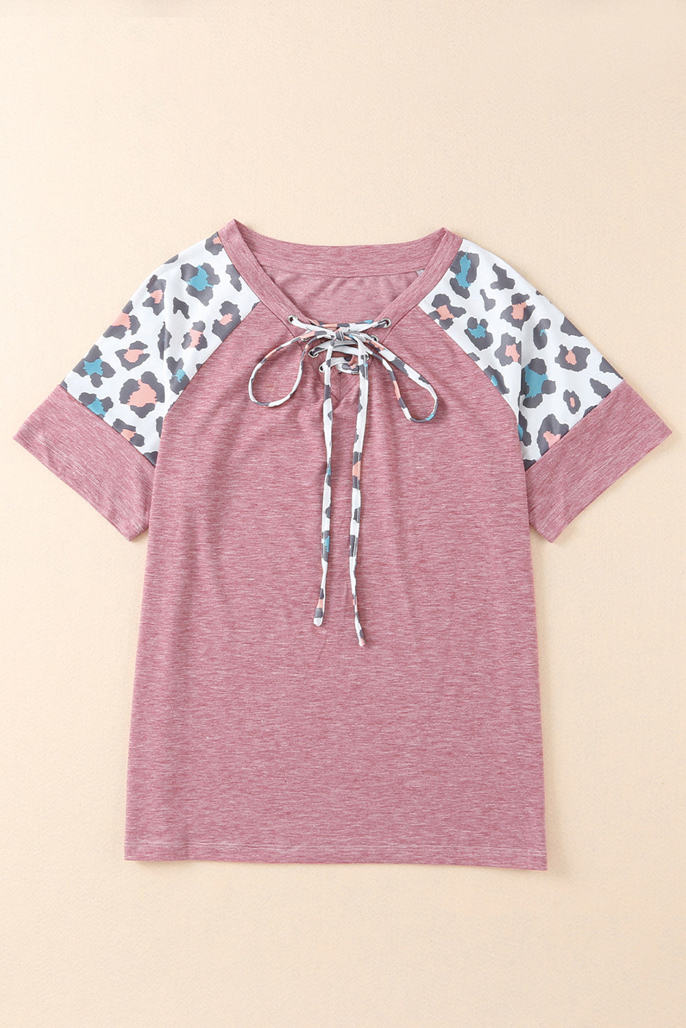 A stylish pink t-shirt featuring lace-up detail and leopard print raglan sleeves, perfect for casual wear.