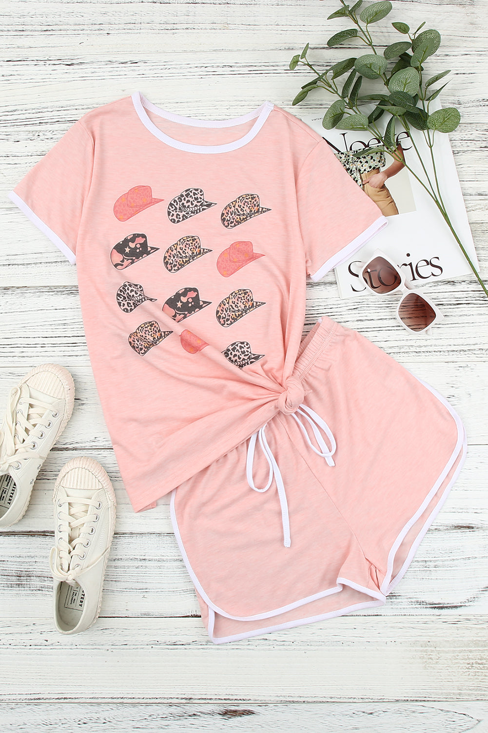 A stylish pink leopard hat print short sleeve t-shirt paired with matching drawstring shorts, perfect for summer lounging.