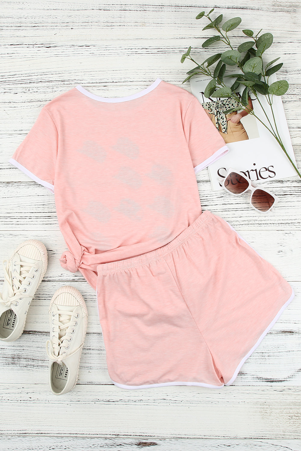 A stylish pink leopard hat print short sleeve t-shirt paired with matching drawstring shorts, perfect for summer lounging.