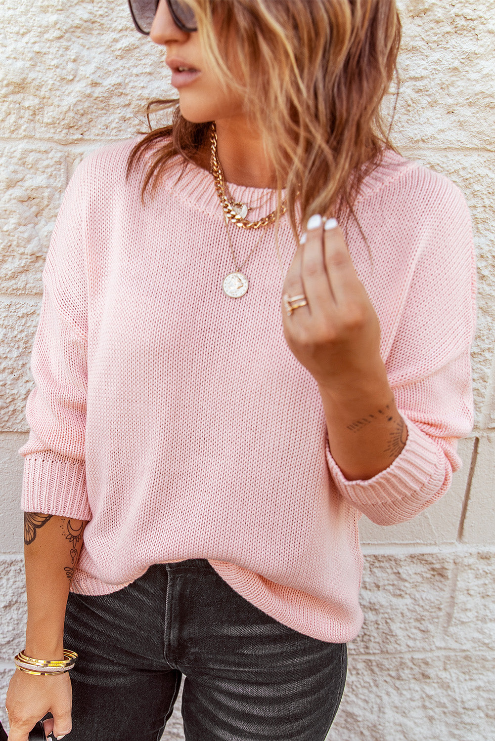 A stylish pink oversize knitted sweater with drop-shoulder sleeves, perfect for winter wear.