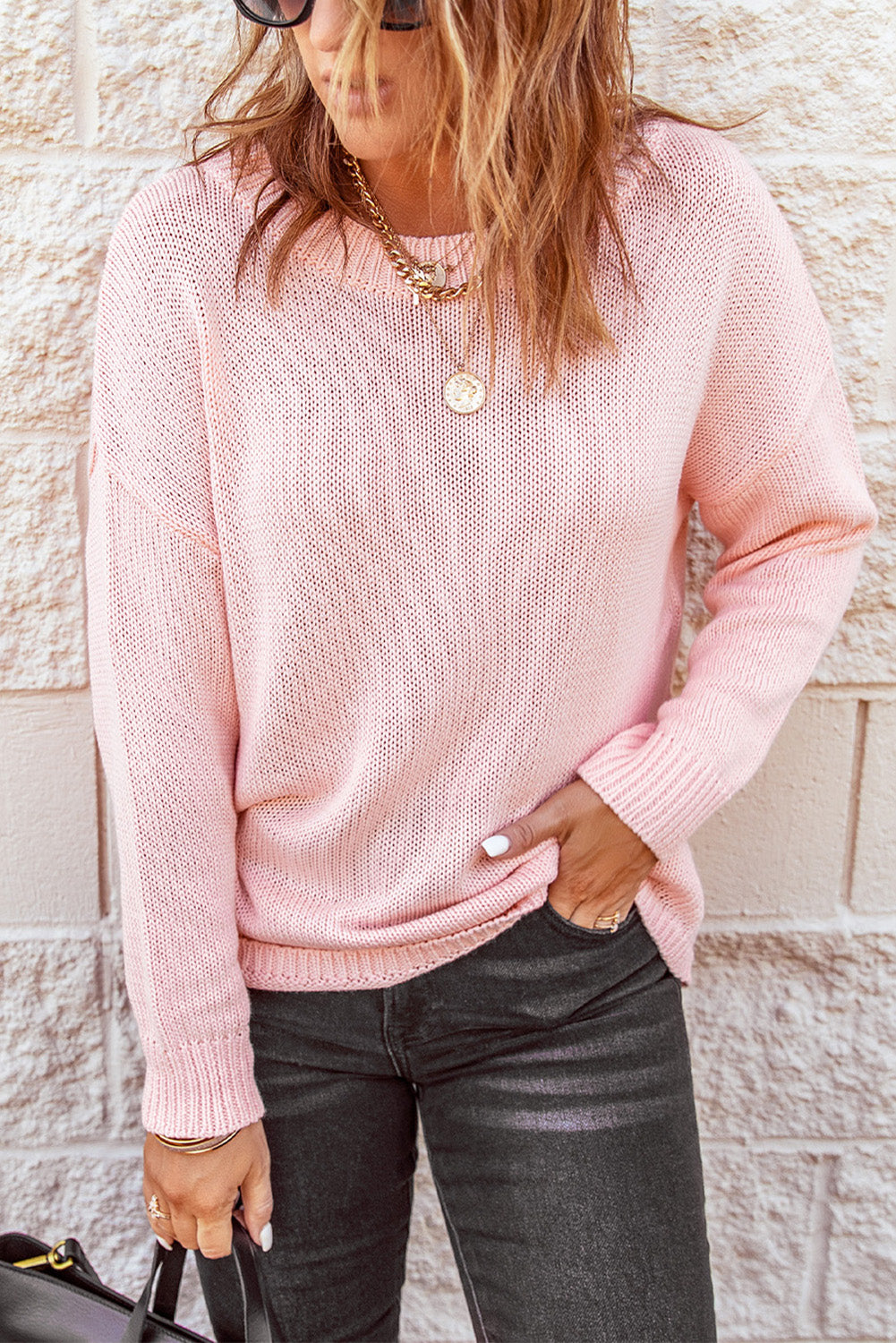 A stylish pink oversize knitted sweater with drop-shoulder sleeves, perfect for winter wear.